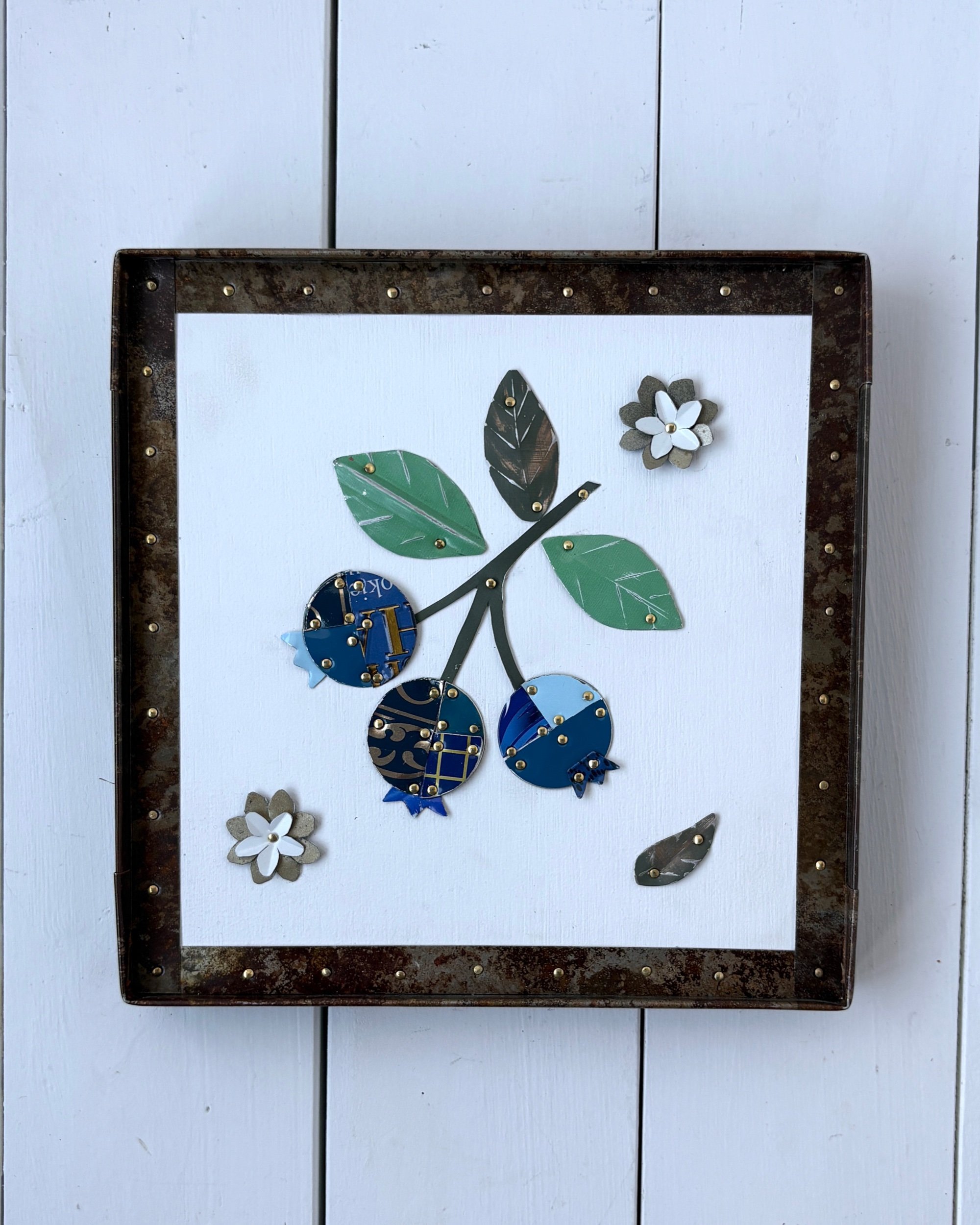 Handmade blueberry tin collage wall art framed in preserved rusty tin with natural patina