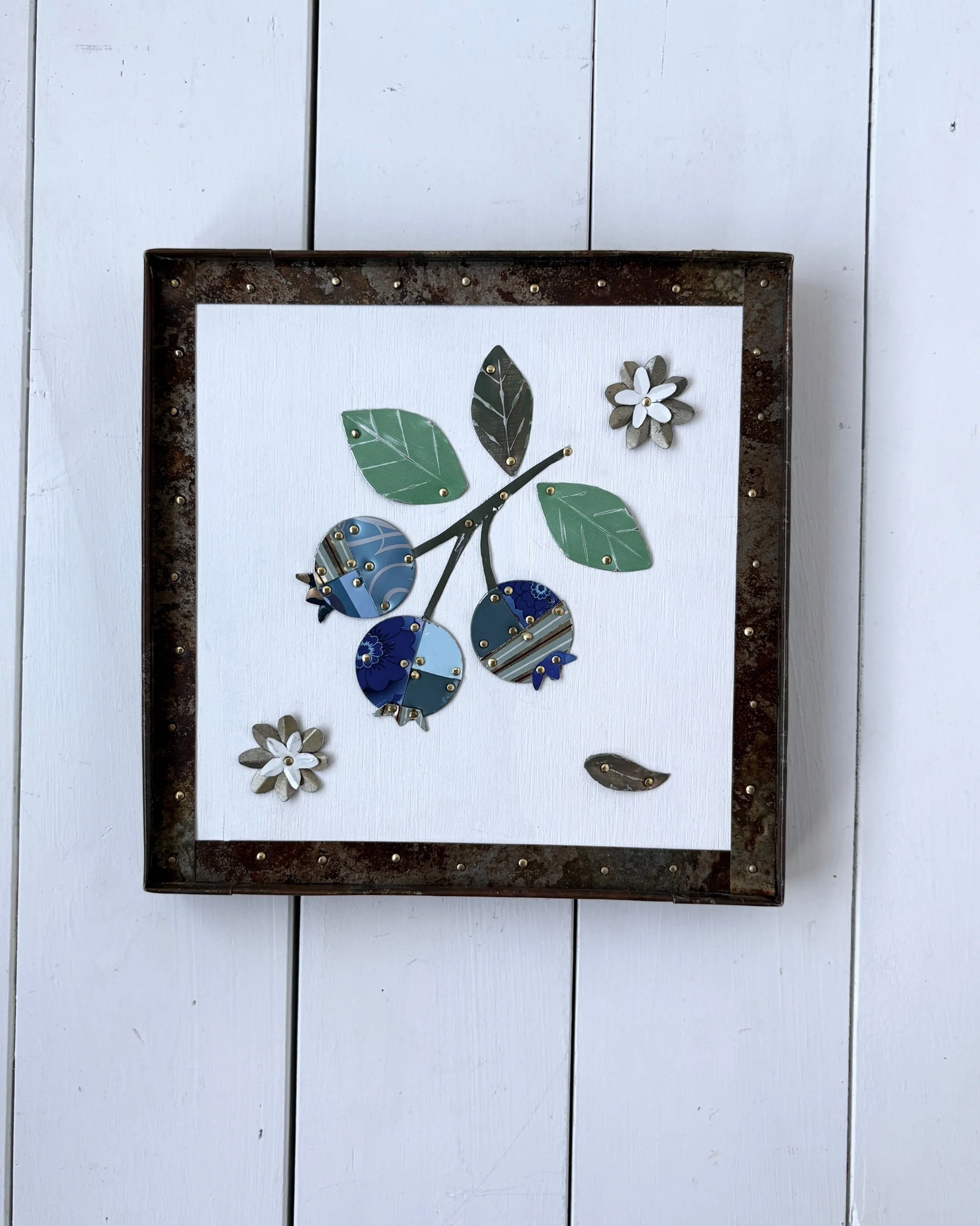 Handmade blueberry tin collage wall art framed in preserved rusty tin with natural patina