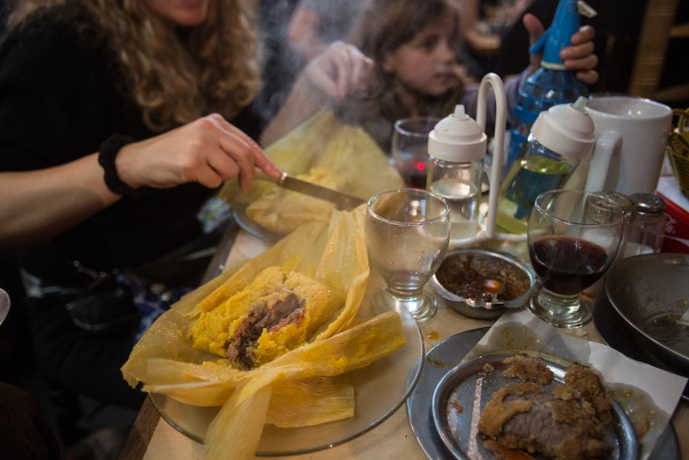  Steaming tamale (foreground), humido (background), hot sauce (center). 