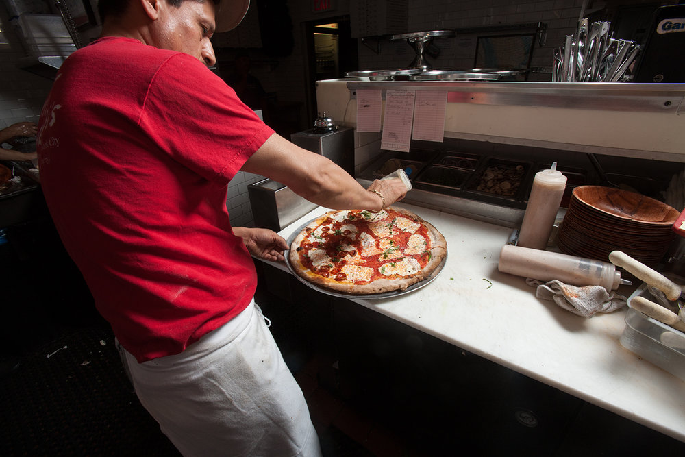  ...but the flavor imparted by a coal-burning oven offers a culinary glimpse into America's pizza past. 