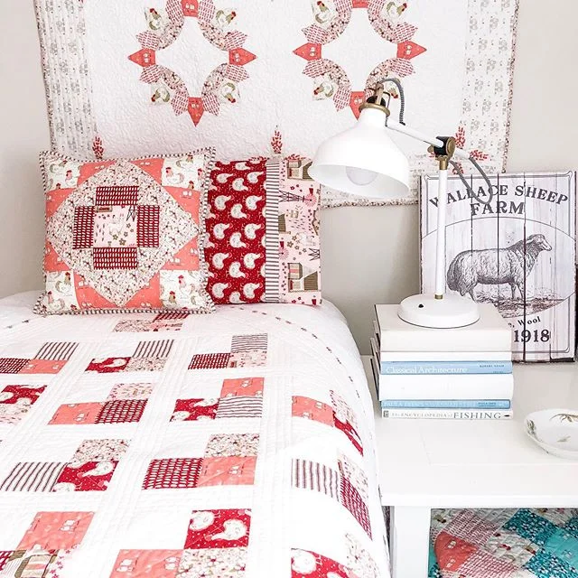 Pink, coral, and burgundy for a sweet snugly bedroom π There are 4 quilt patterns here- The Brimfield Block by @brimfieldawakening, Quilty Hearts by @emily_dennis_ ,both the Meadowland quilt block pillow and tucked away for when it’s colder, S