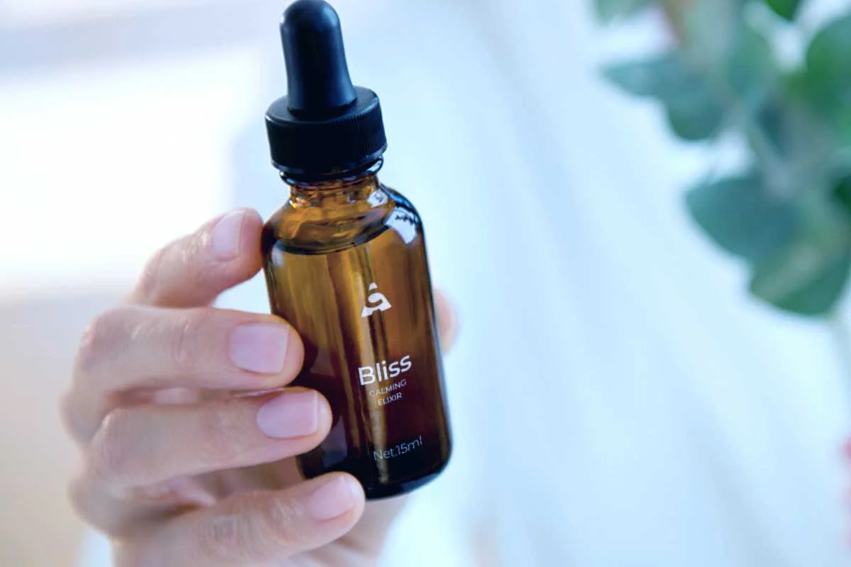 woman-holding-essential-oil-dropper-bottle.jpg