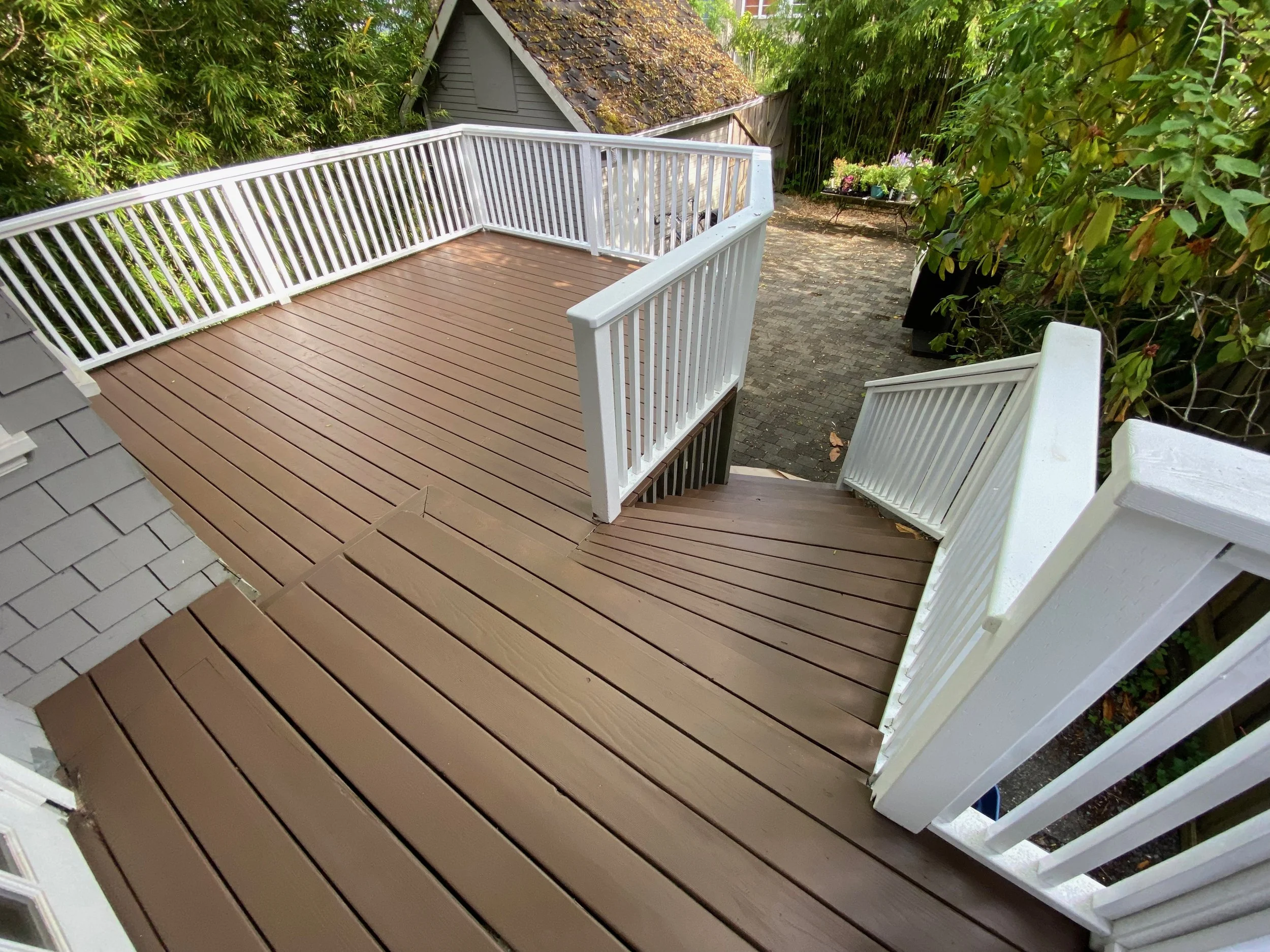 Large exterior deck painted in warm chocolate brown
