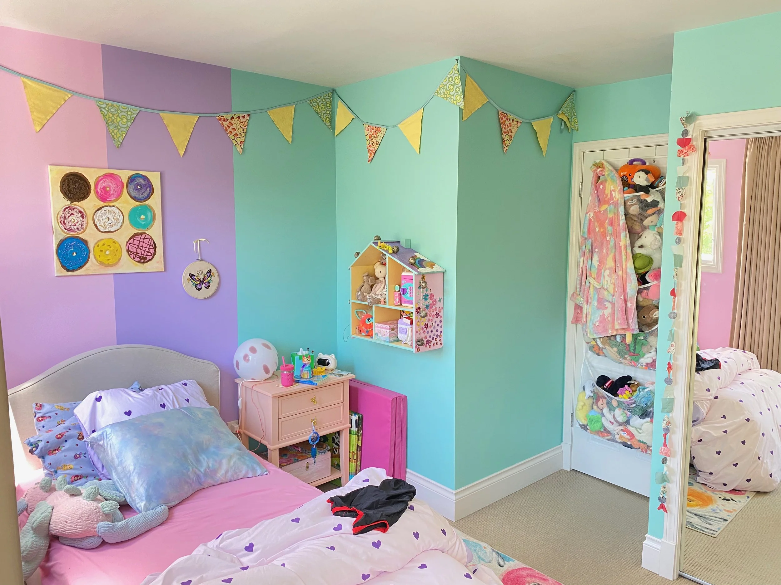 Colourful kids’ bedroom with turquoise, lavender and pink feature walls.