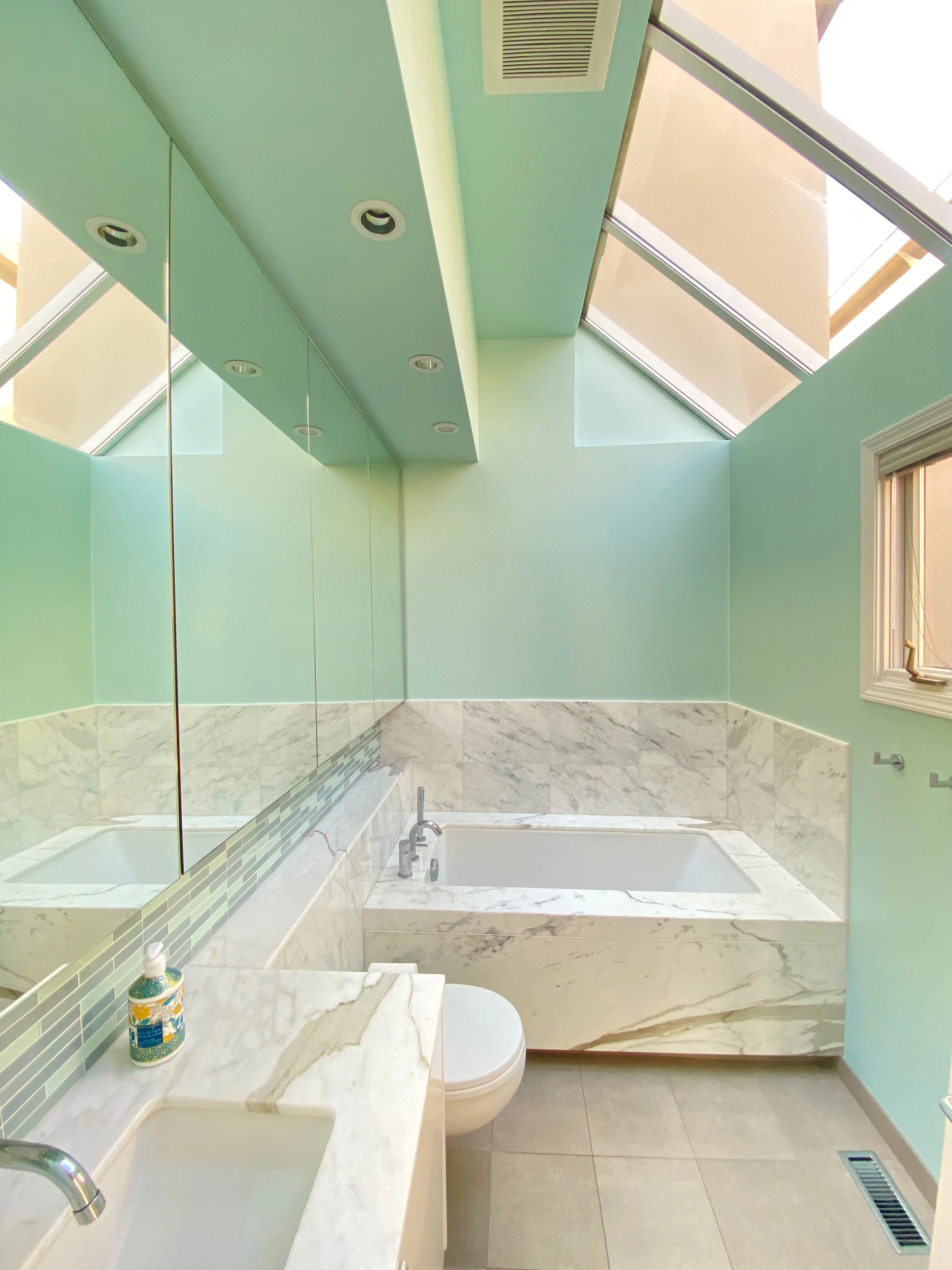 After image of modern bathroom interior painted in seafoam green