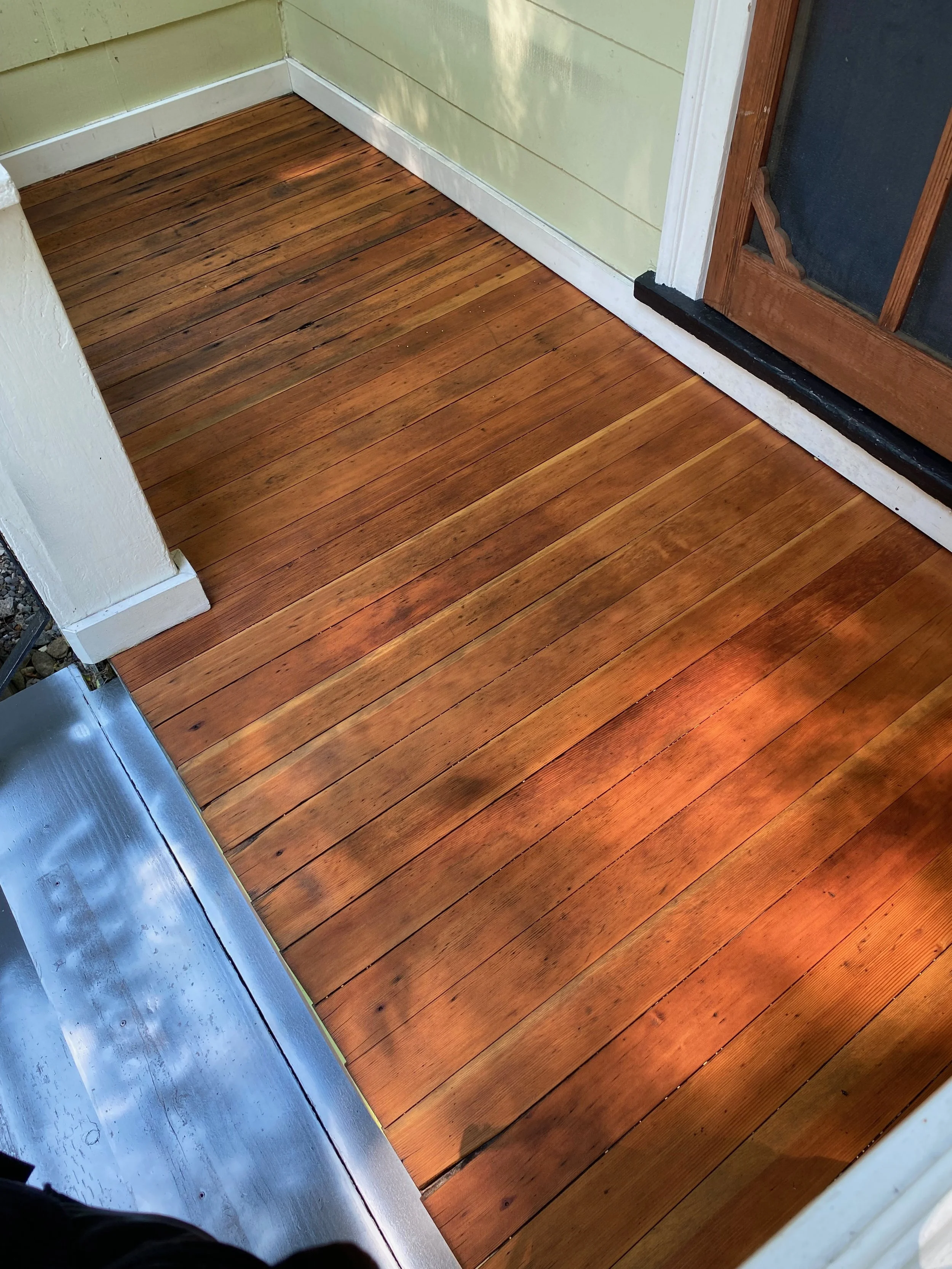 Freshly stained front porch landing
