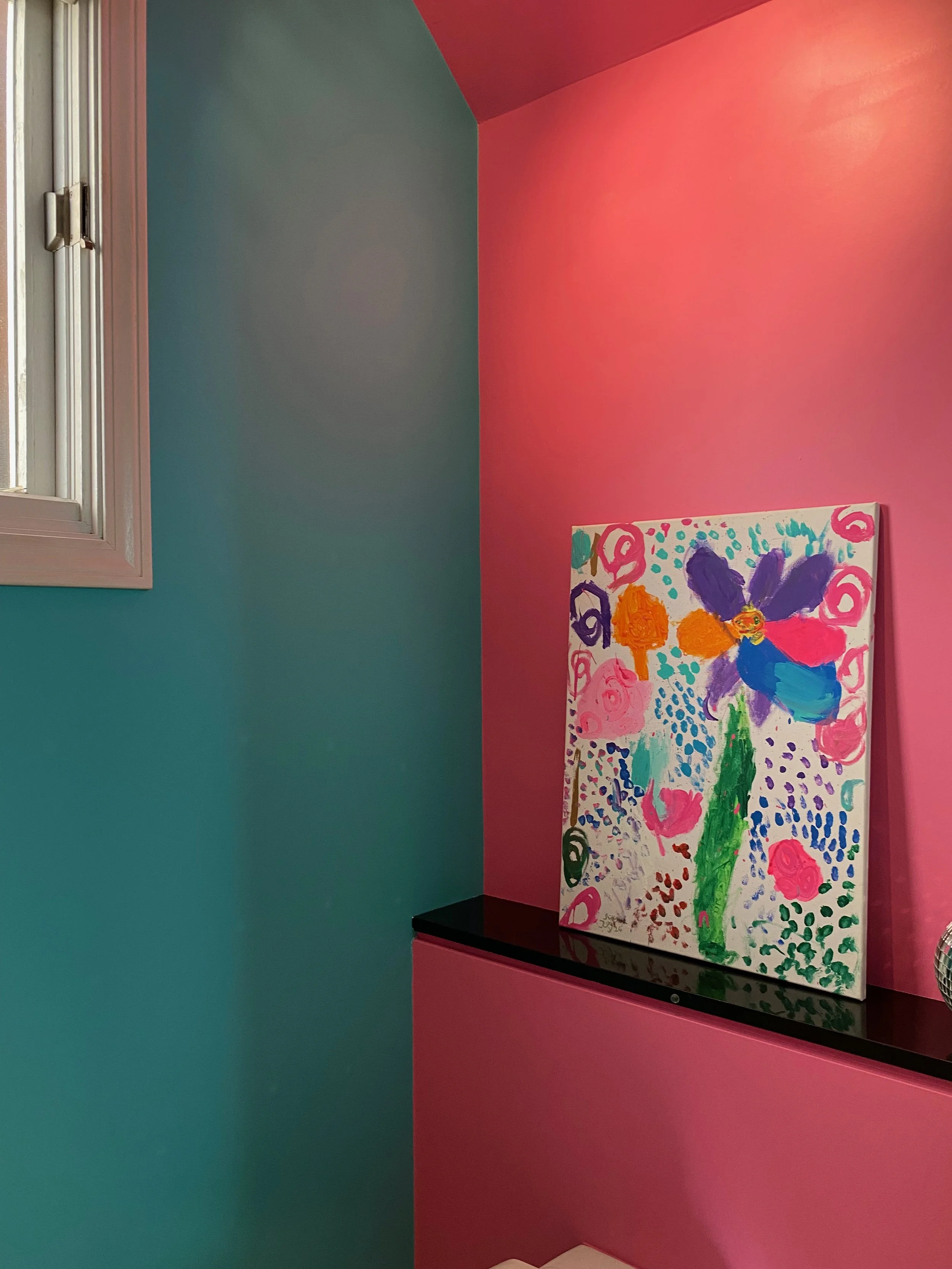 Interior powder room painted in turquoise and pink