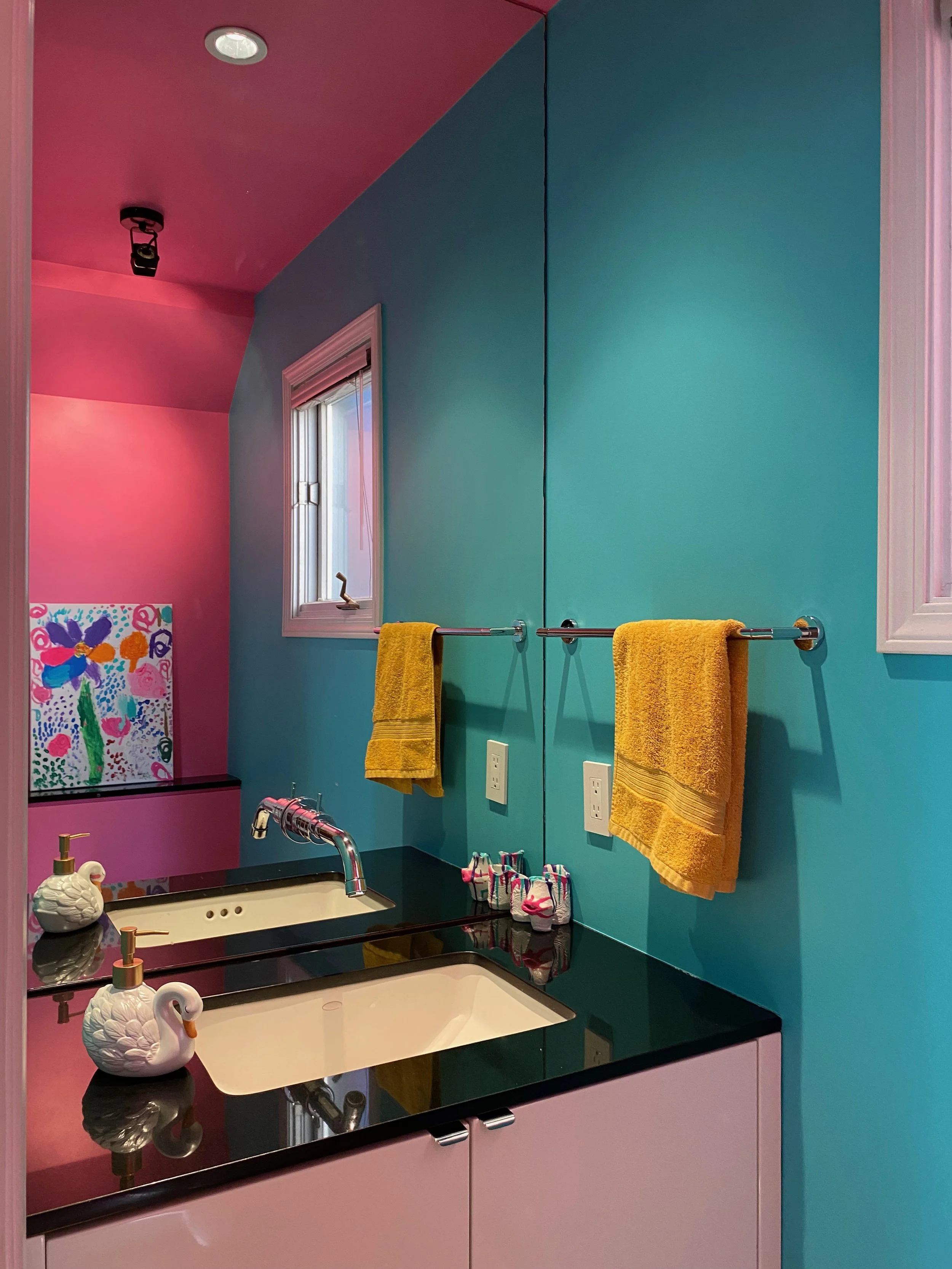 Interior powder room painted in turquoise and pink
