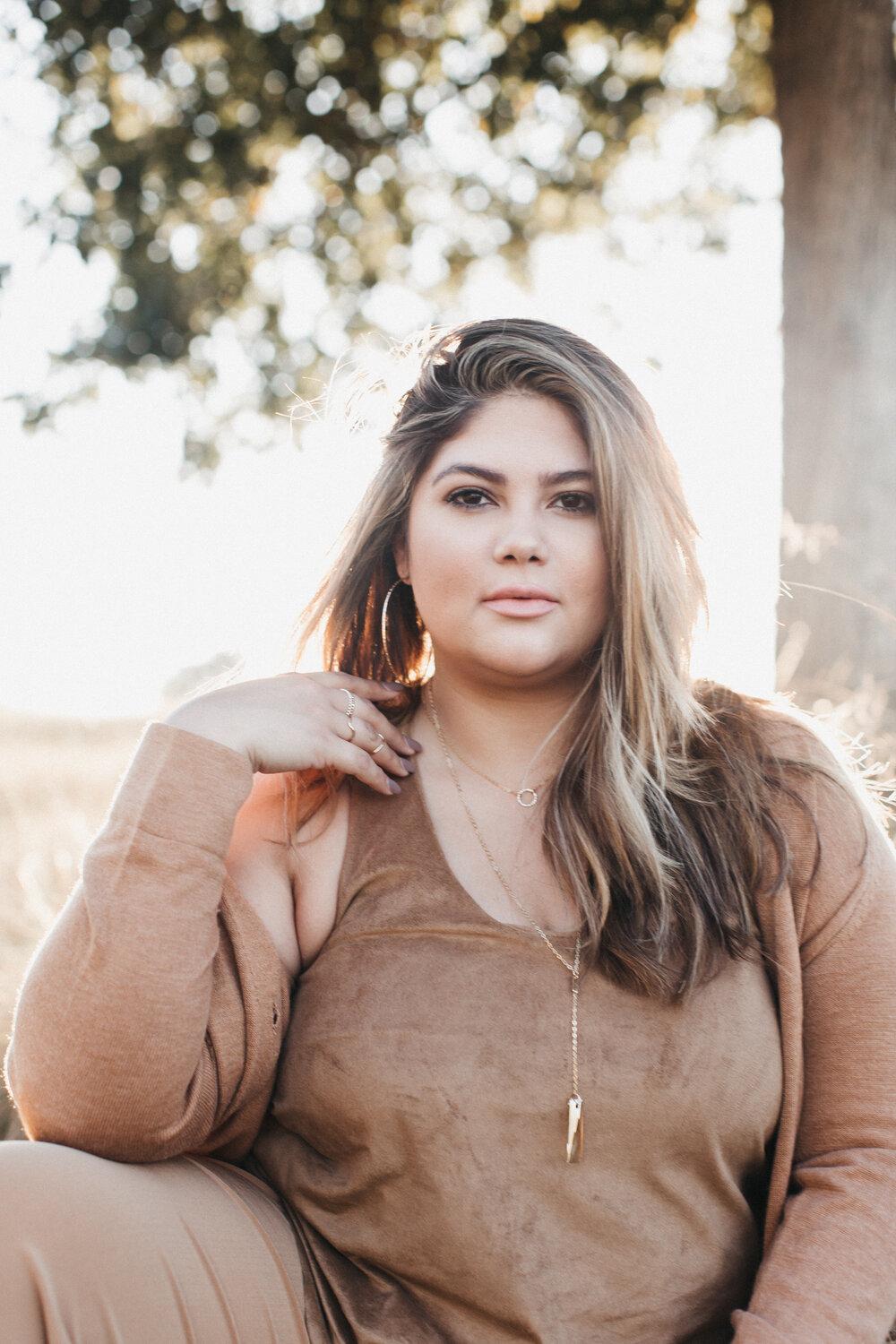Desiree is wearing the 18” Signature Shape Necklace , Holiday Rectangle Necklace, and the Ashley Hoop .