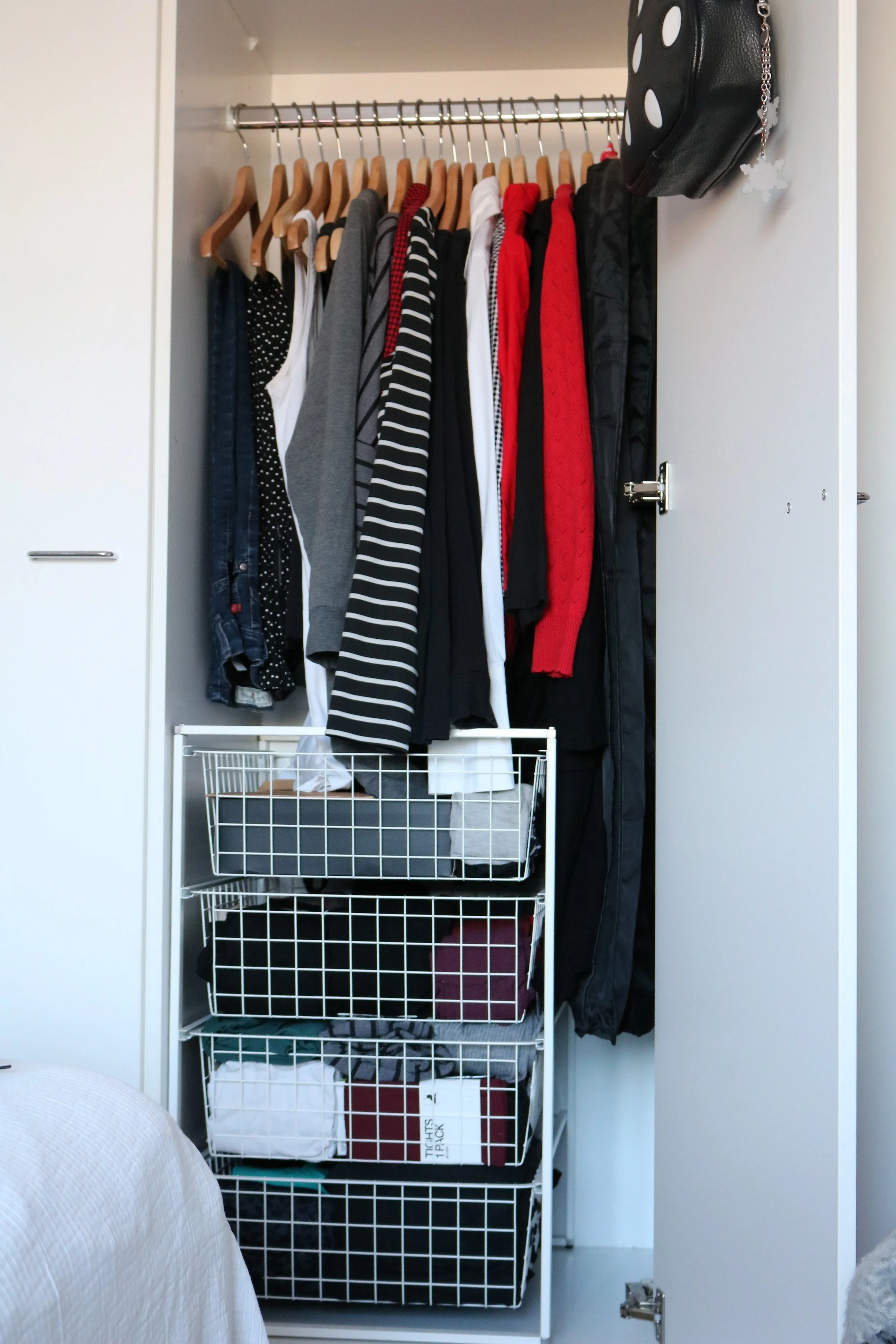 Everything in regular use, excluding shoes and outerwear, fits in the closet quite comfortably. I keep a few dresses in reserve inside the clothes covers on the right.