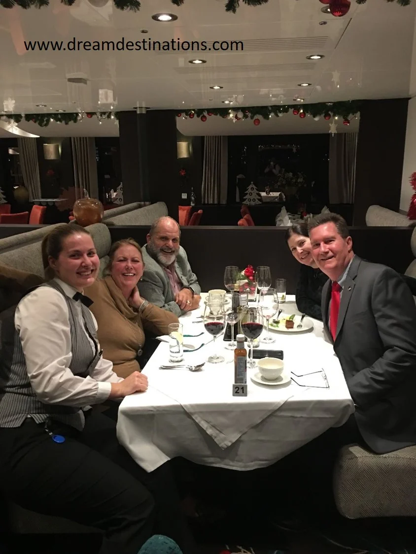 AmaKristina Dining Room with our Bar Waitress Misha, the Schrader’s (left) and the Thomas’s (right) at table 21 after an awesome meal