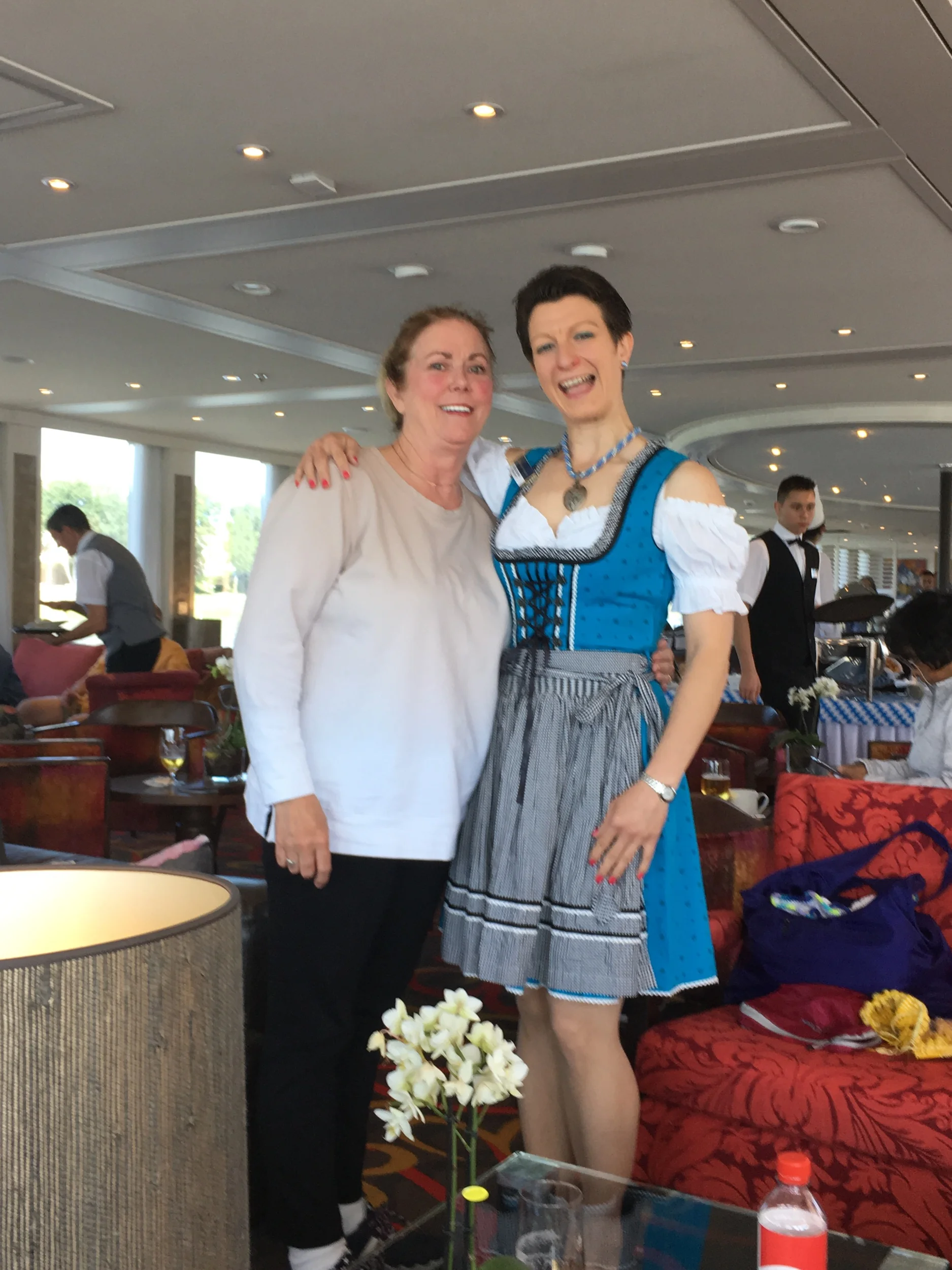 Anne with Jess at German food party while sailing—see the hard working crew in the background?