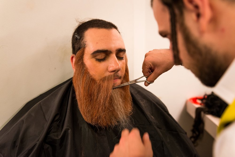 Crepe-hair beard being trimmed backstage