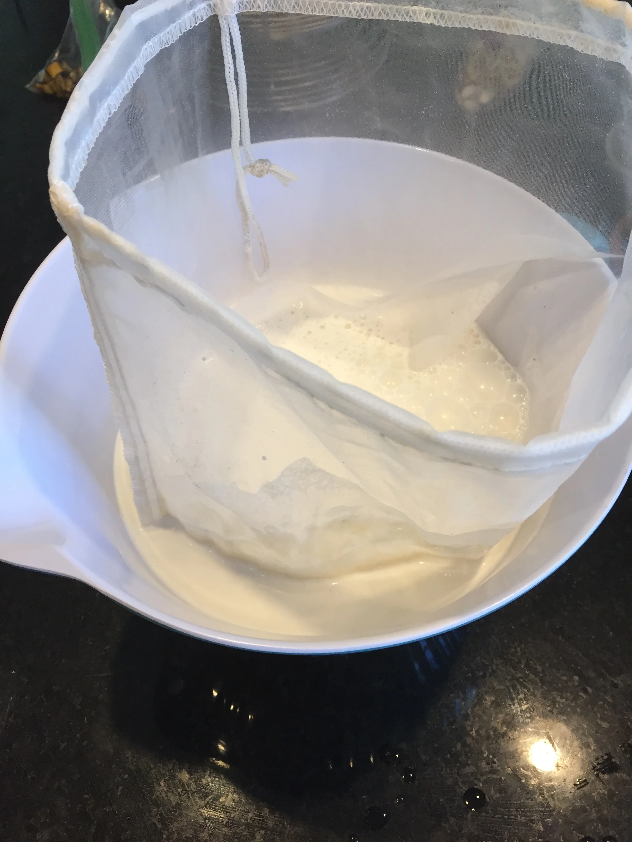 Straining the cashew milk.