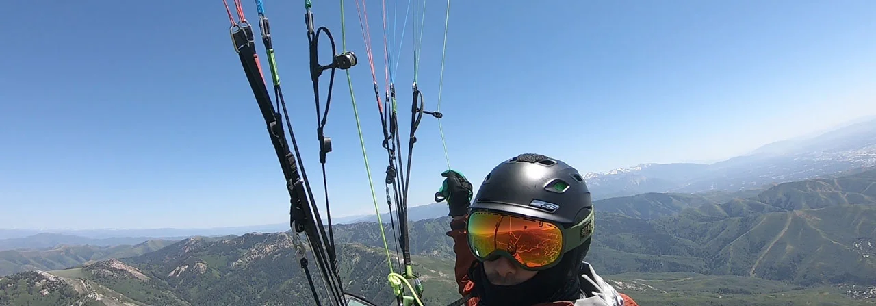 The author captures the moment preparing to transition towards Salt Lake City just beyond the foreground ridge-line.