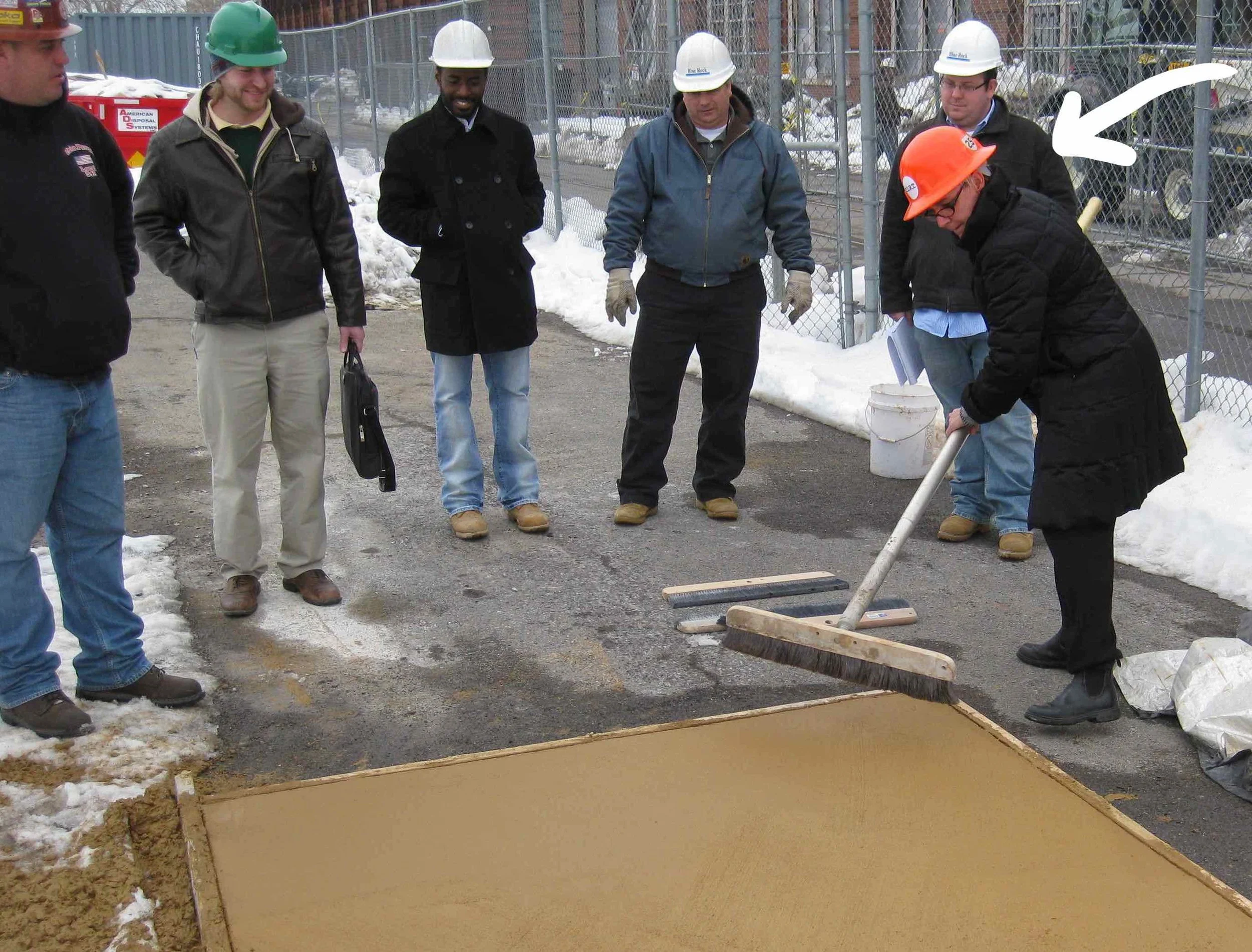 Julie Bargmann - yes that’s her under the big arrow - demonstrates the “crazy broom” finish technique on a concrete mock-up.