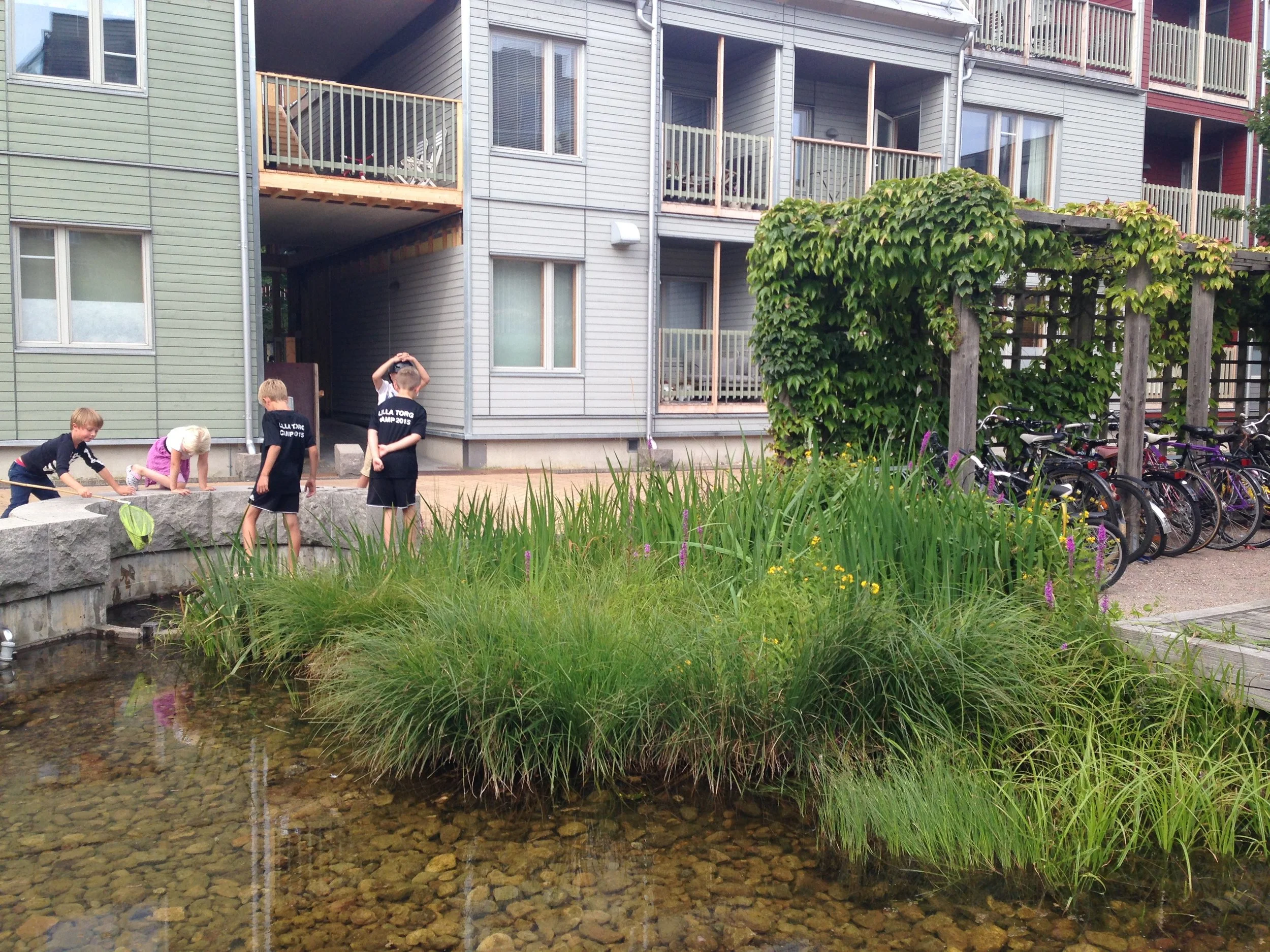 Children playing in a back street pocket park in Malmo, Sweden.