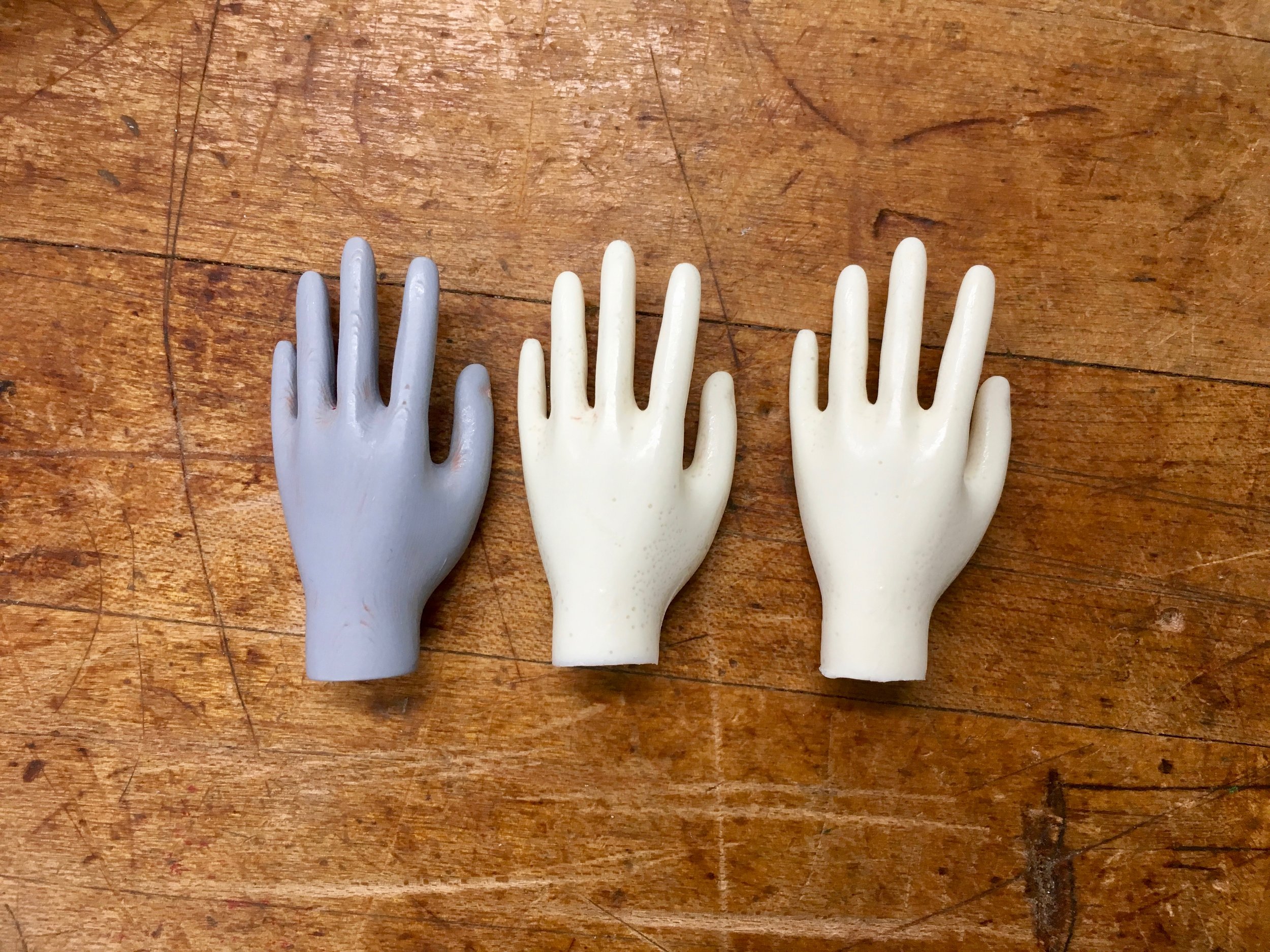 Original part next to two casted parts.