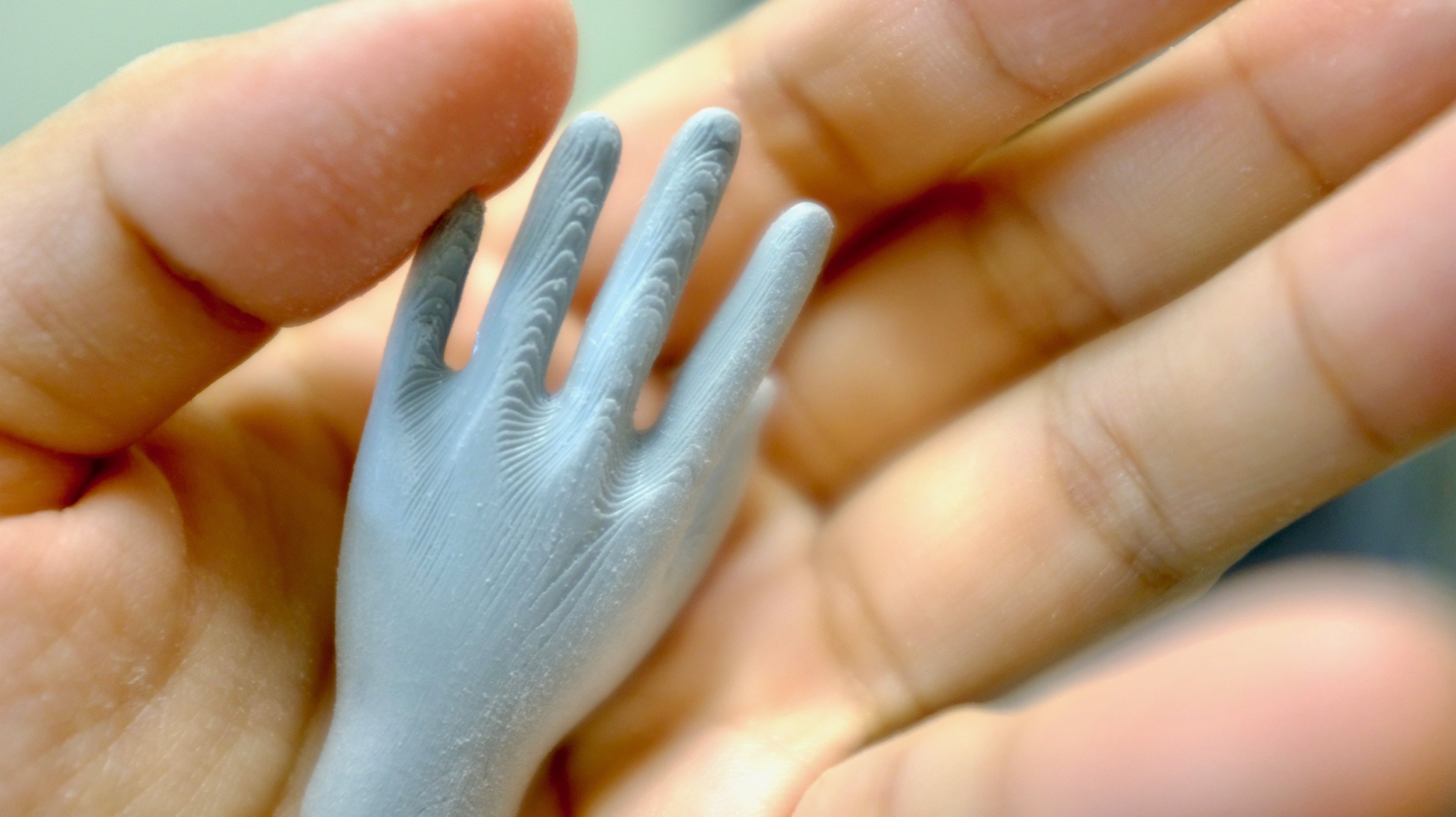 Partially sanded, larger 3-D printed hand.