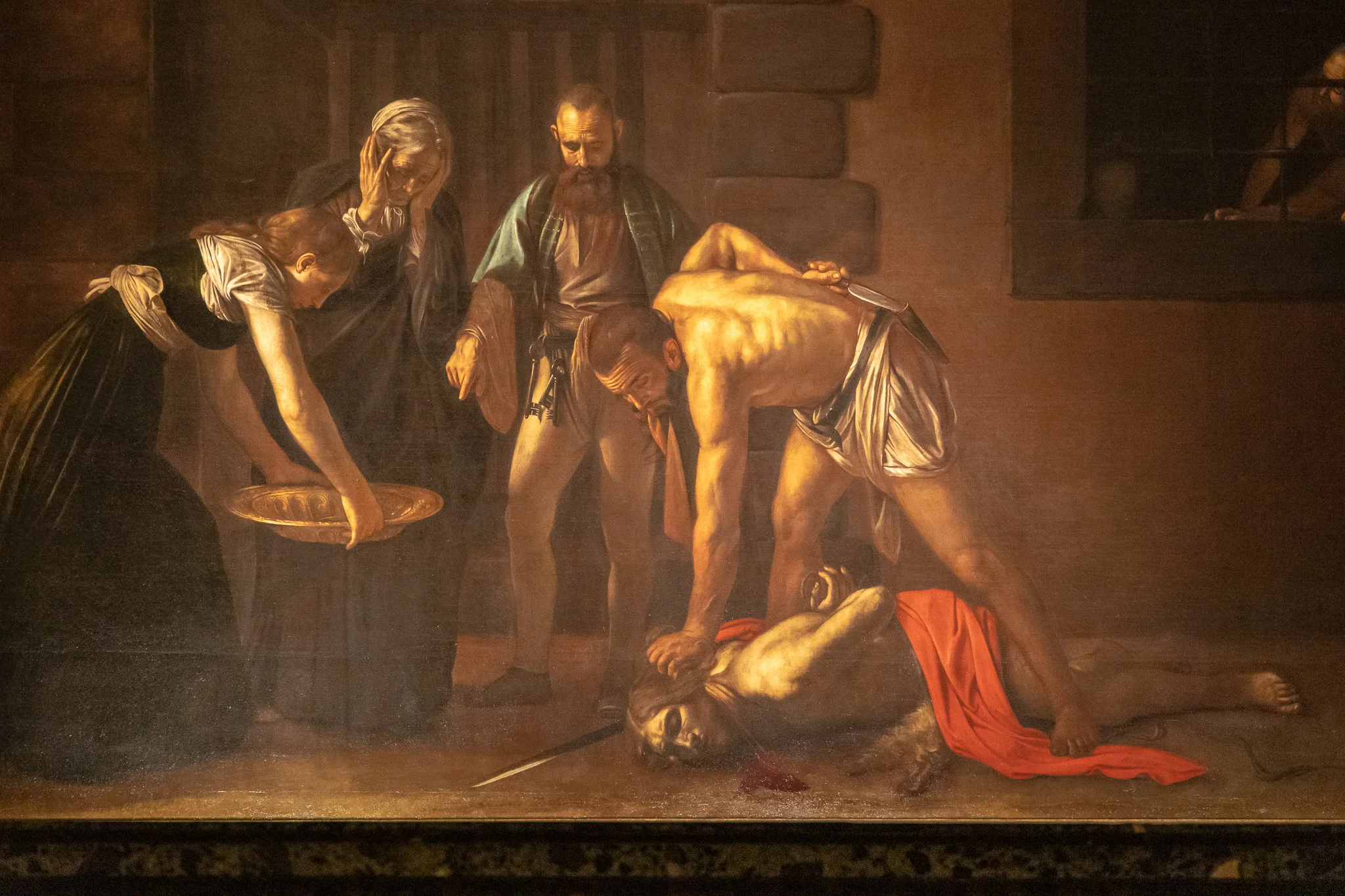 Somewhere in that blood is supposed to be Caravaggio’s signature
