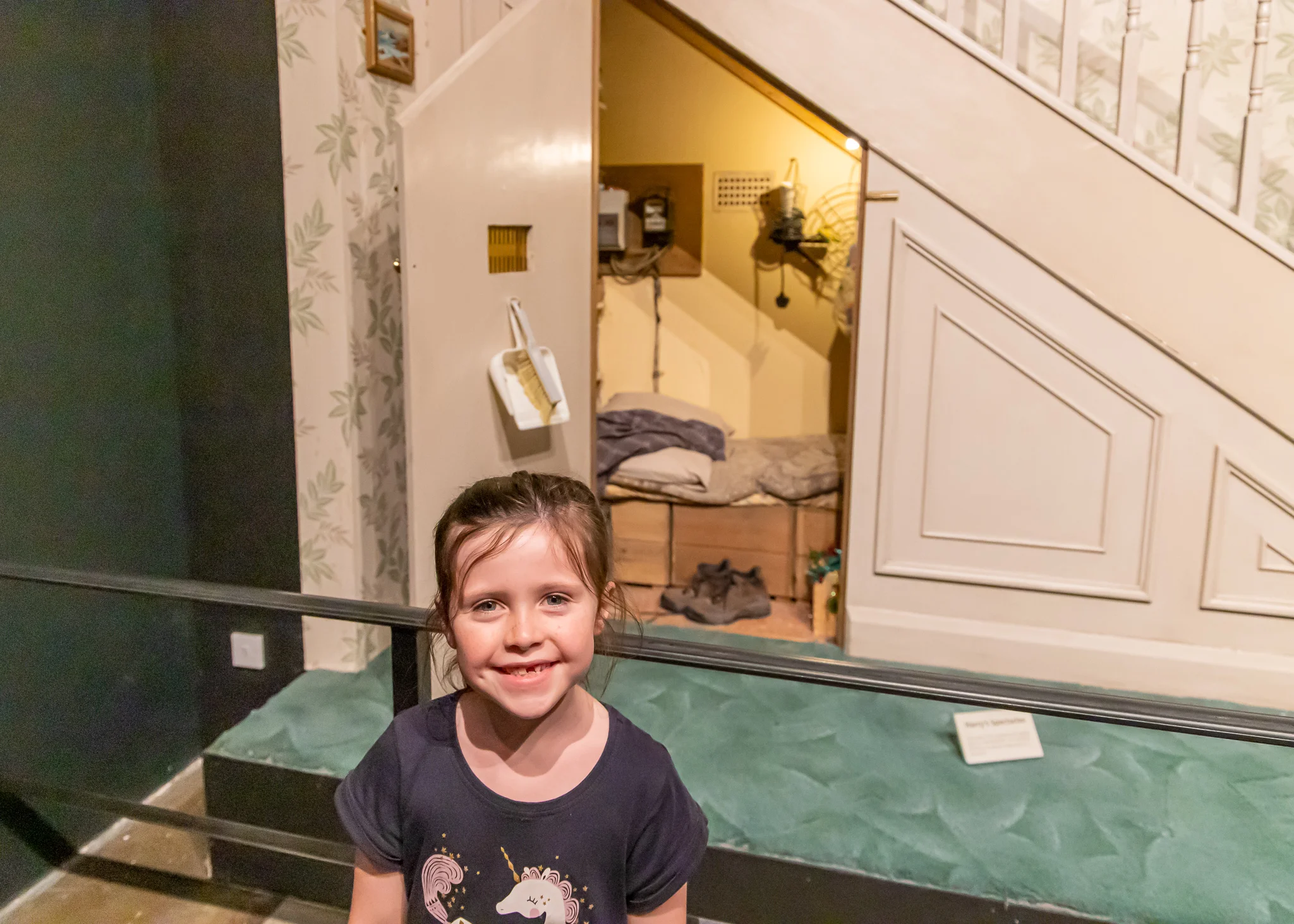 Emmy outside Harry’s room underneath the stairs