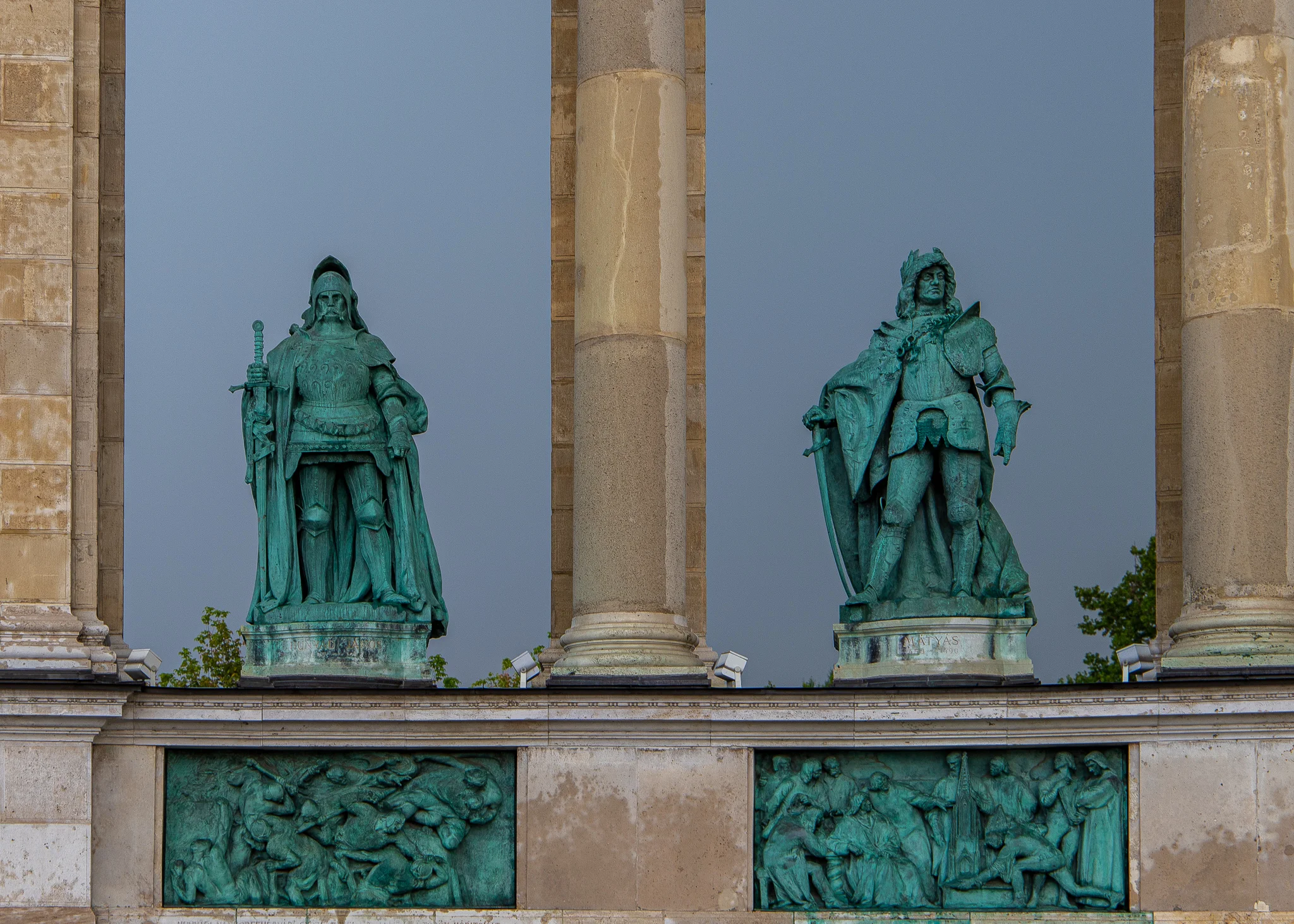 Statues of John Hunyadi (left) above the Siege of Belgrade and King Matthias Corvinus (right) above a scene depicting him with his scholars