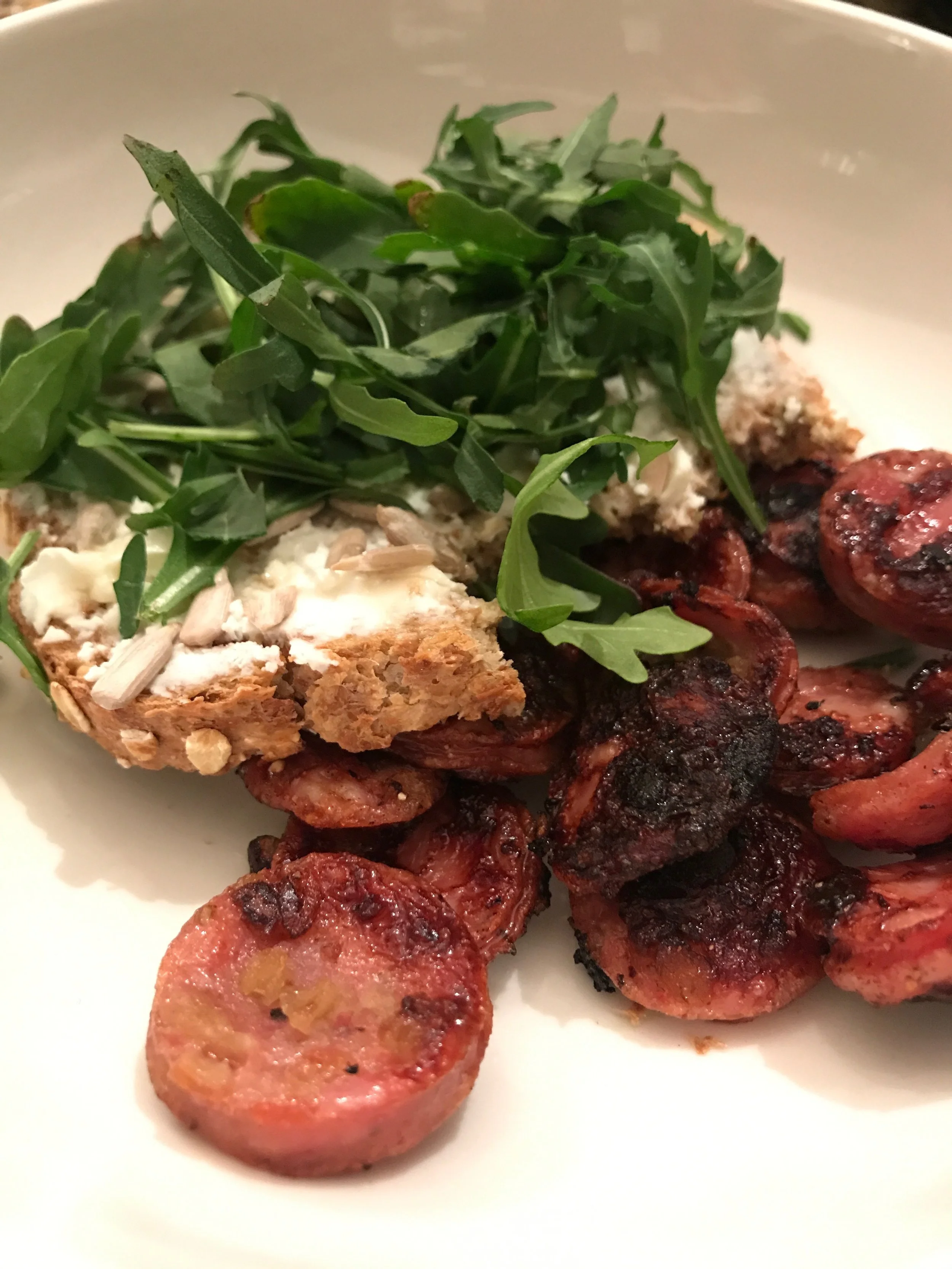 My cravings get weird... super-crispy Aidell's Apple Chicken Sausage & Ezekial toast w/ goat cheese, honey, sunflower seeds, and arugula.