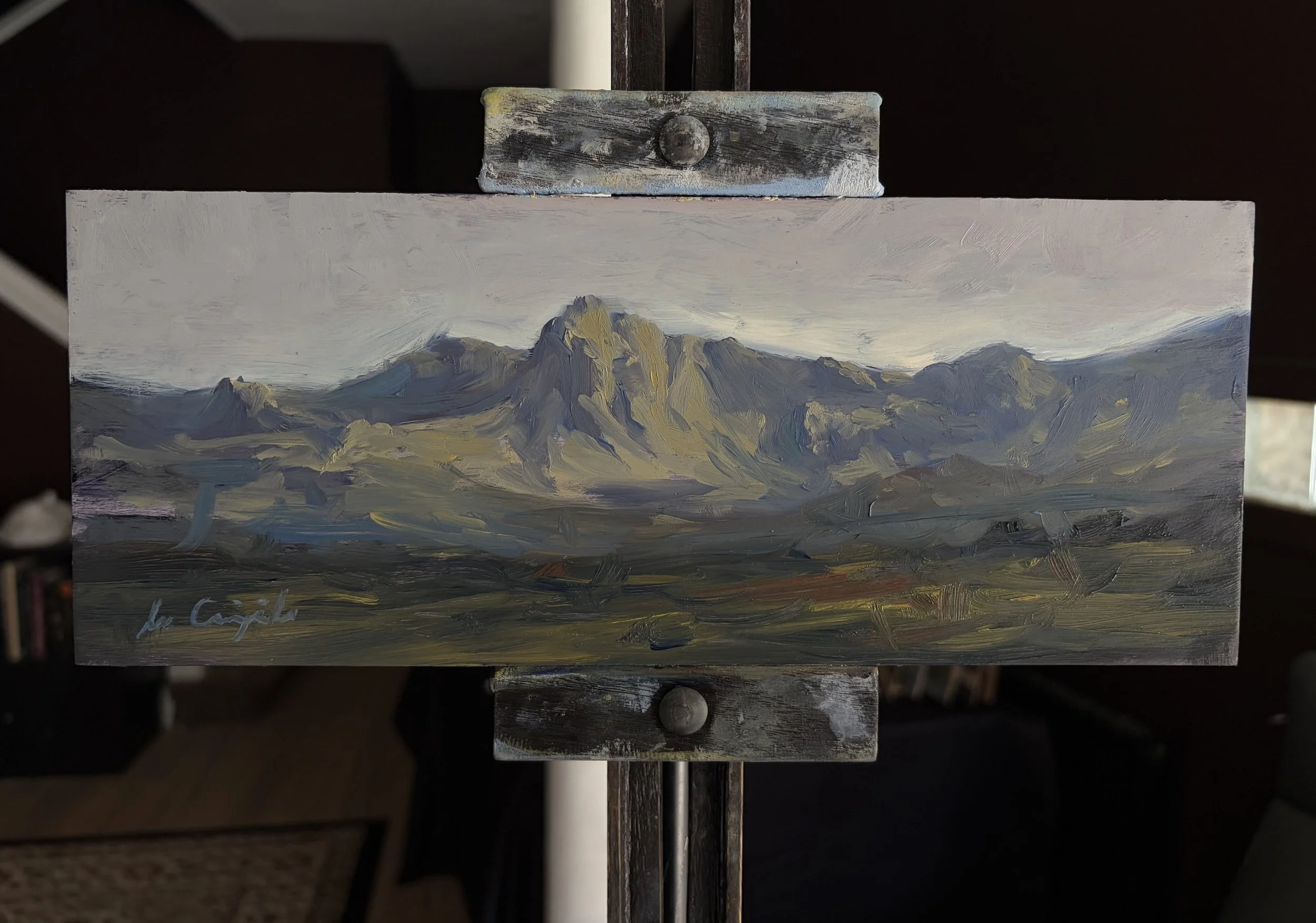 Original oil painting of the Trotternish Ridge displayed on a studio easel by Scottish artist Lee Craigmile.