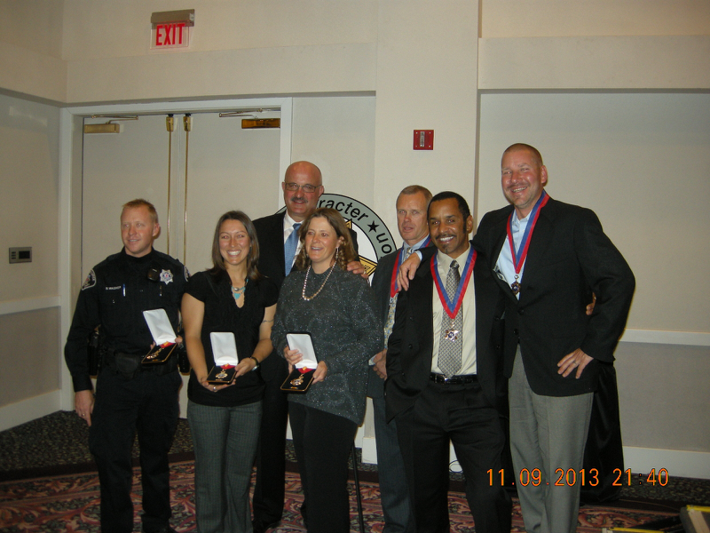 Author and group of rescuers receiving the Silver and Bronze Star Medals for life saving efforts in Lyons.