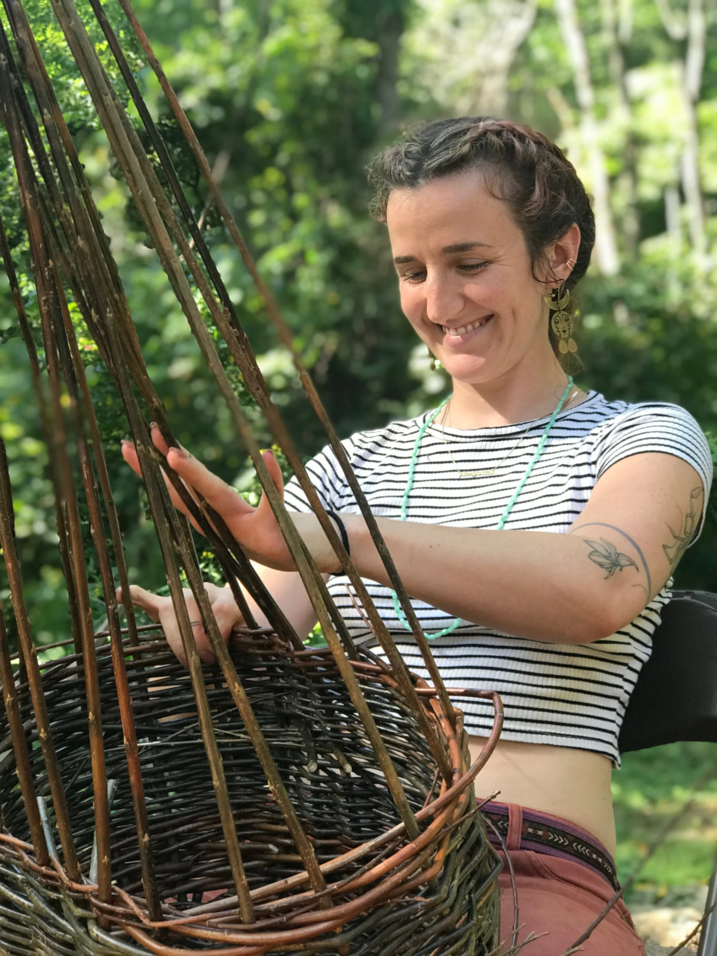 woman weaving willow basket