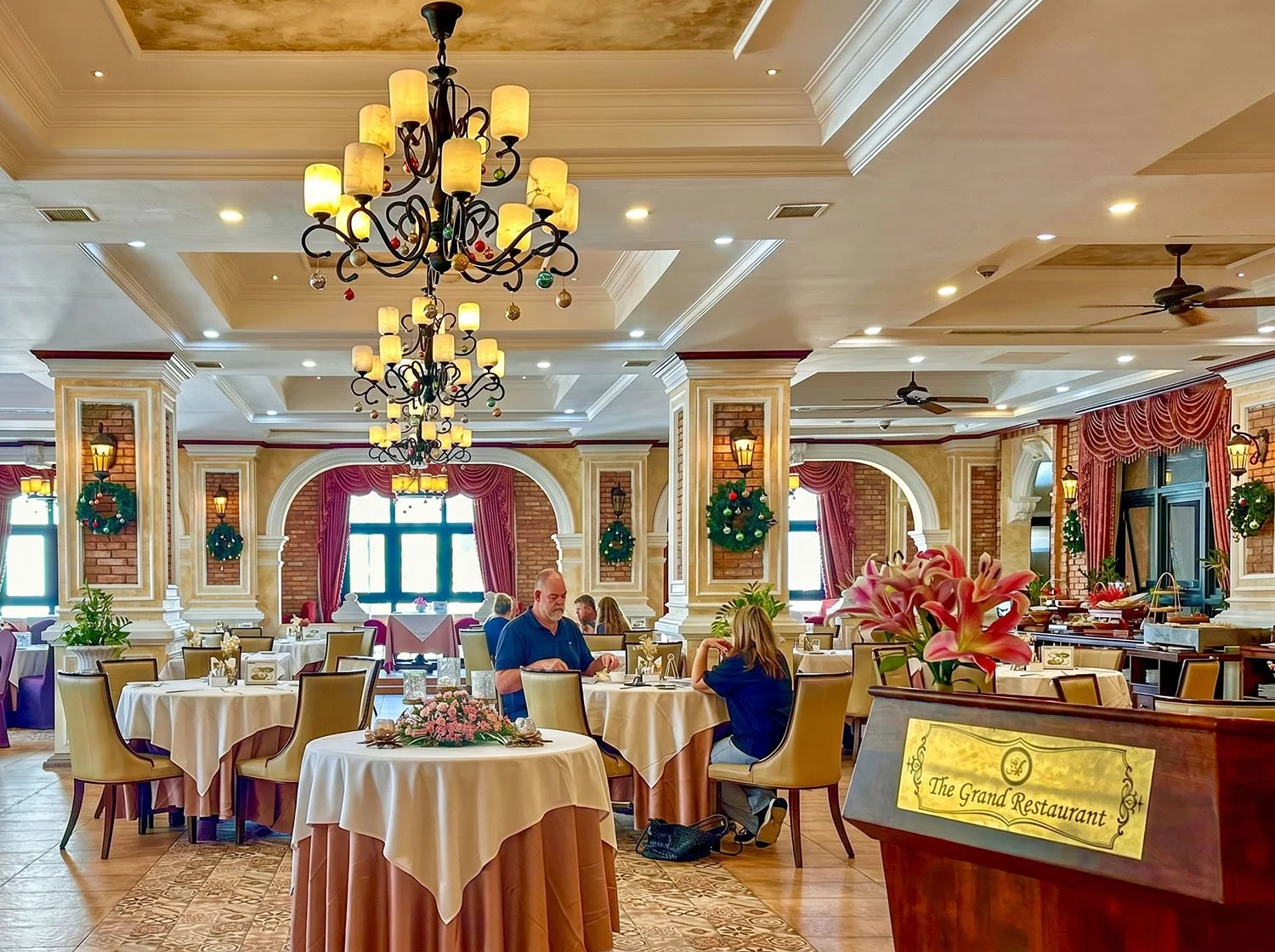 Interior view of an ornately decorated restaurant inside the Anik Palace Hotel, Phnom Penh, Cambodia, with about six diners eating at the table