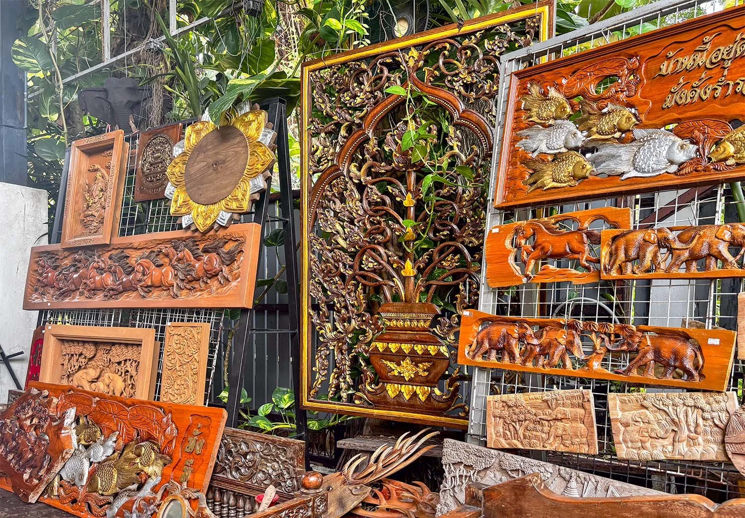 A display of intricate Lanna wood carvings at a workshop near Chiang Mai in Thailand.
