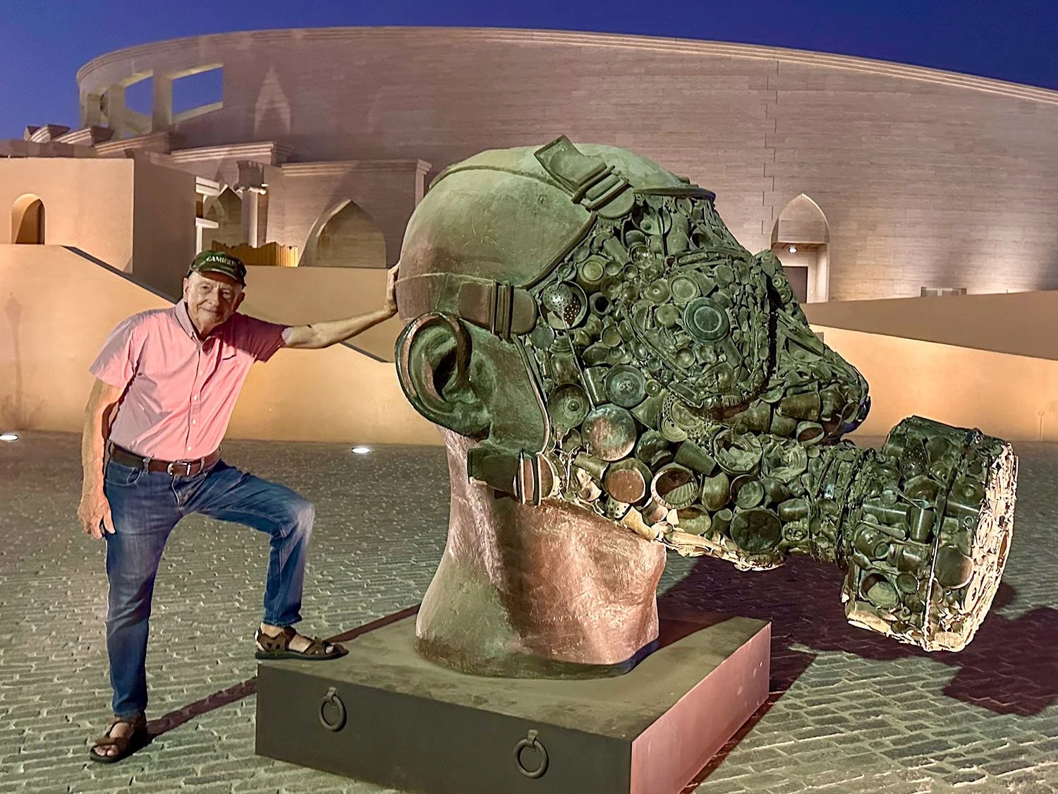 A large ans surreal sculpture of the head of a man wearing a gas mask at Katara Cultural Village, Doha, Qatar.