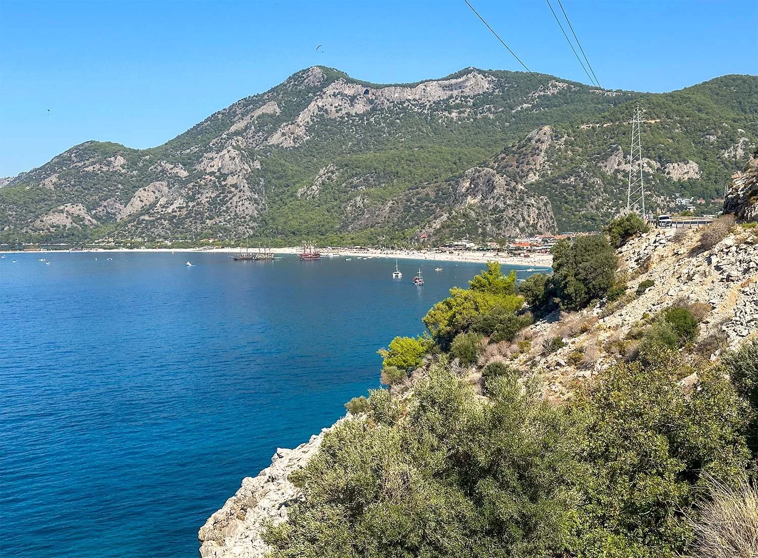 View along the rocky coast of the Turkish Riviera with Ölüdeniz Beach in the background.