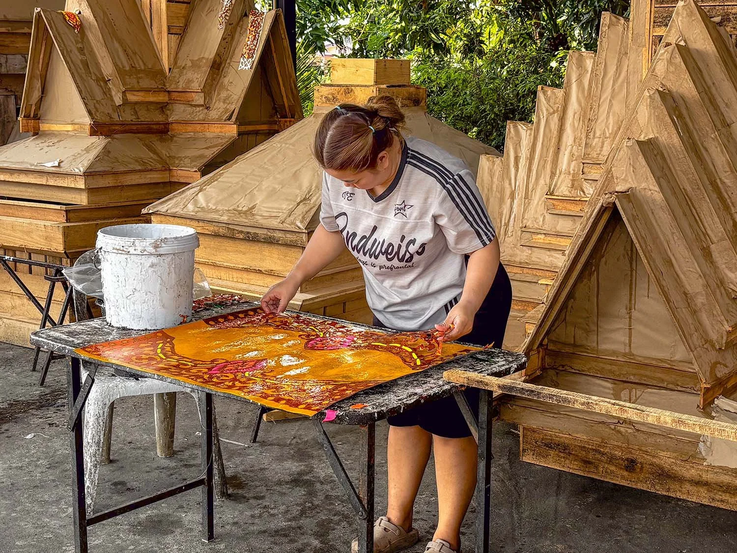 A woman works on the construction of a funeral house in a workshop near Chiang Mai in Thailand.