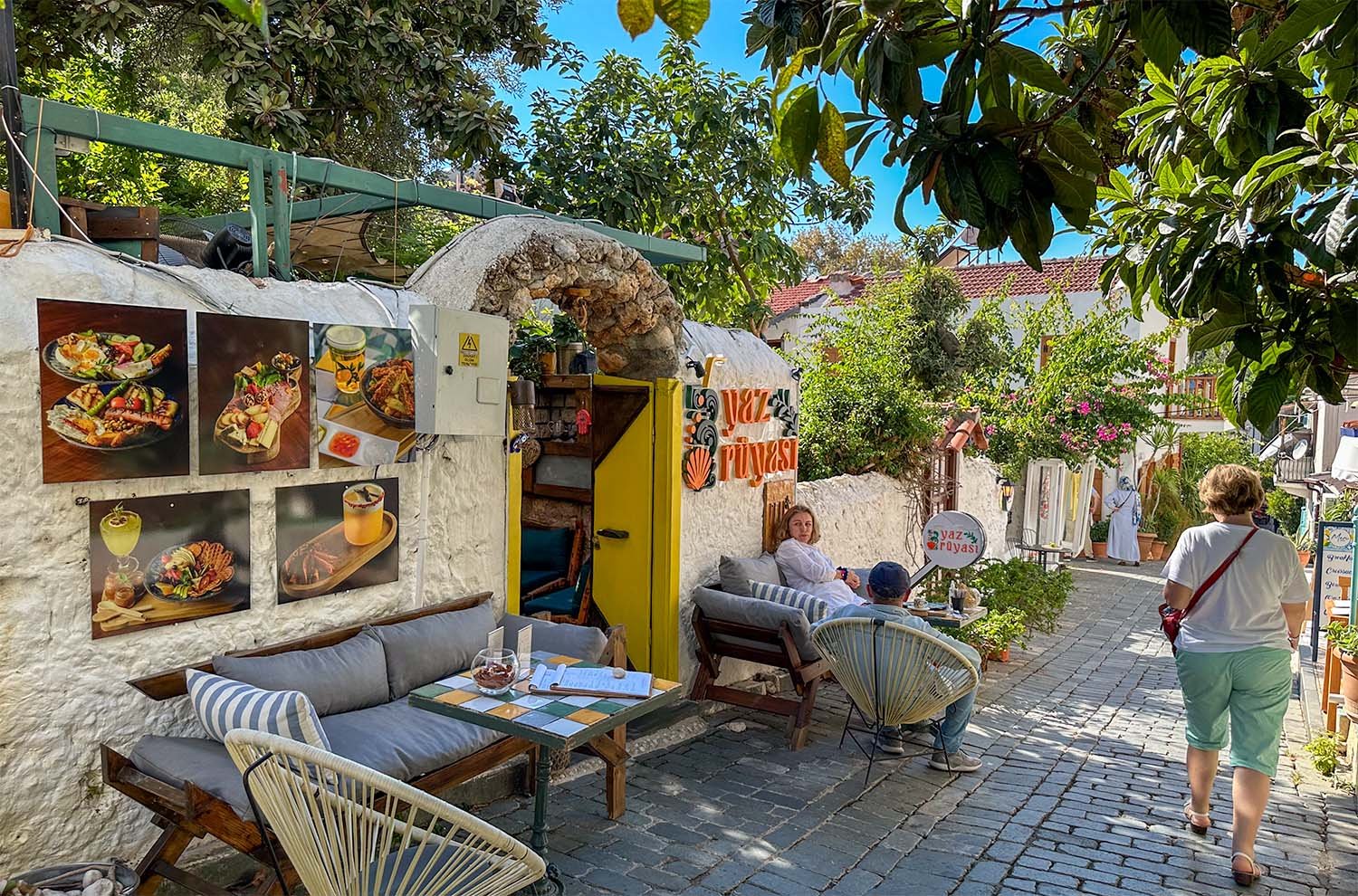 Tourists relax outside a cafe on a narrow street on the Turkish Riviera.