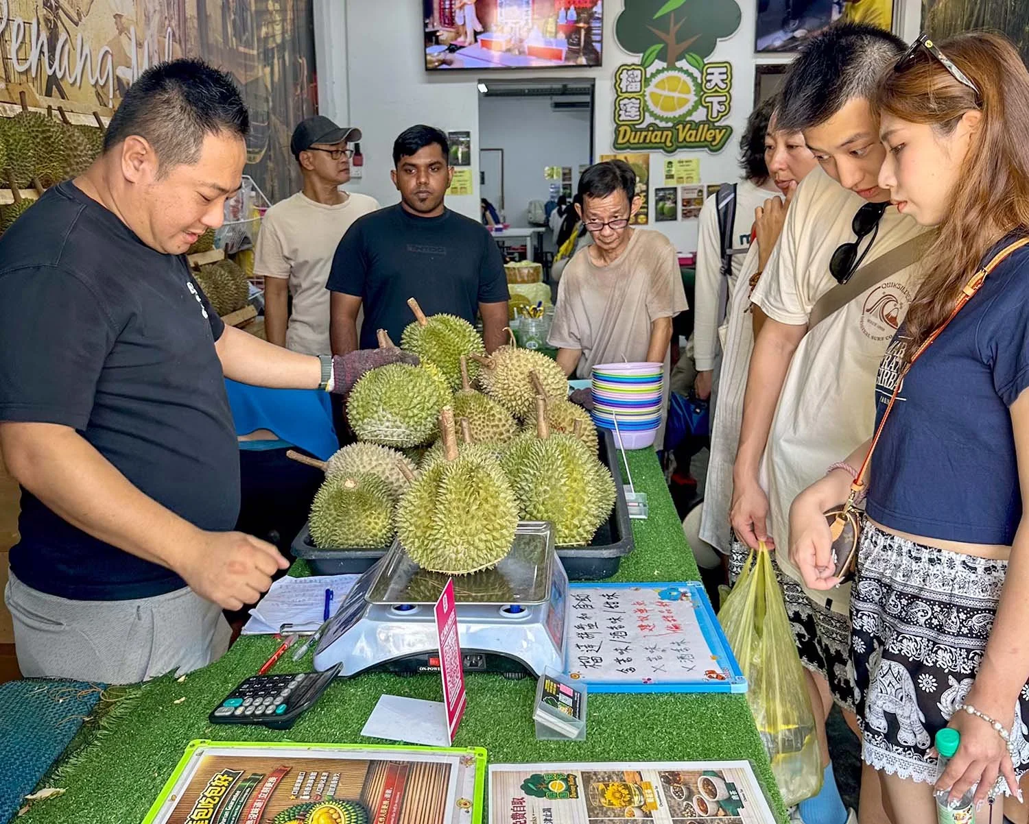 Interior view of a busy durian shop in George Town, Penang, Malaysia.
