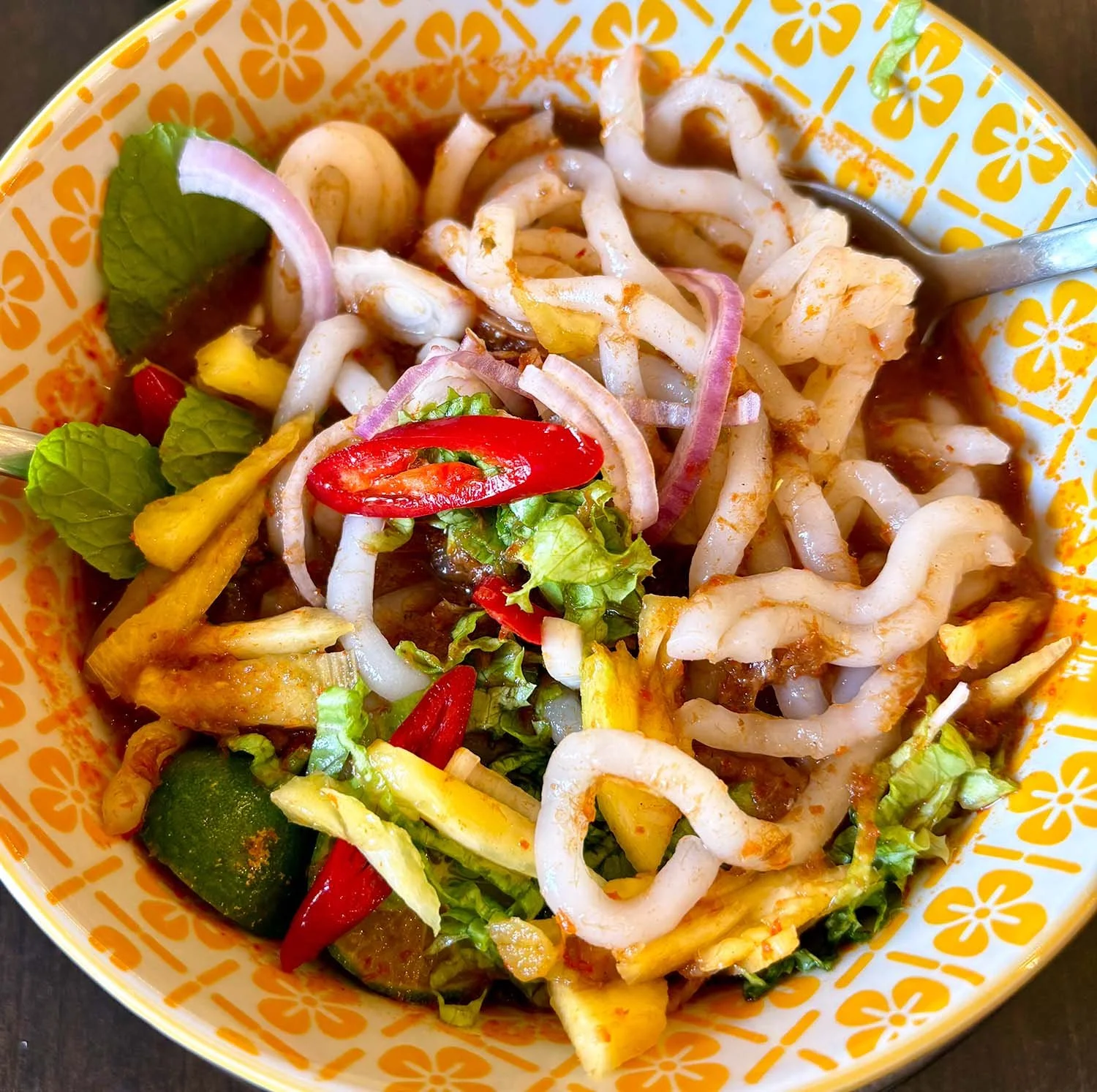 Close-up view of a bowl of laksa - a traditional Malaysian noodle dish.