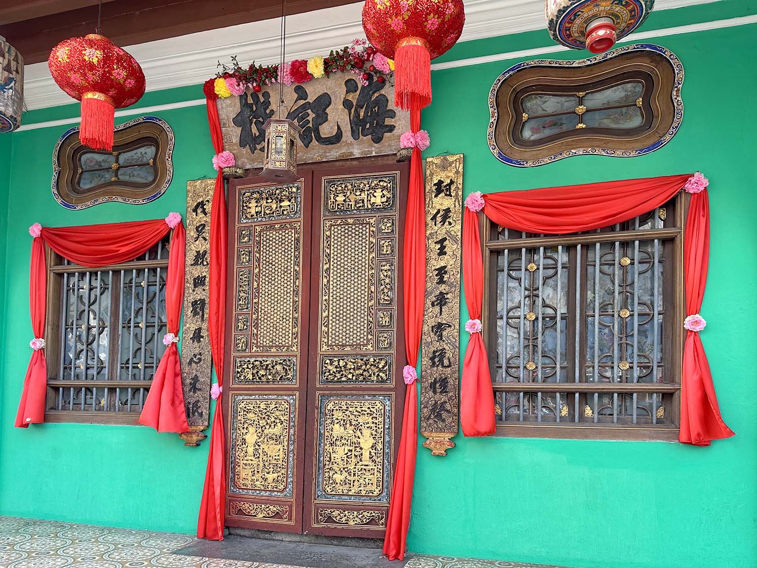 A colourful and ornate street door at the Pinang Peranakan Mansion in George Town, Penang, Malaysia.