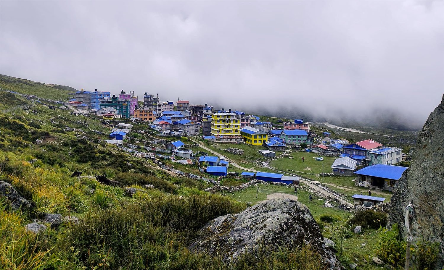 A colourful mountain settlement on the rugged Himalayan landscape of Nepal.