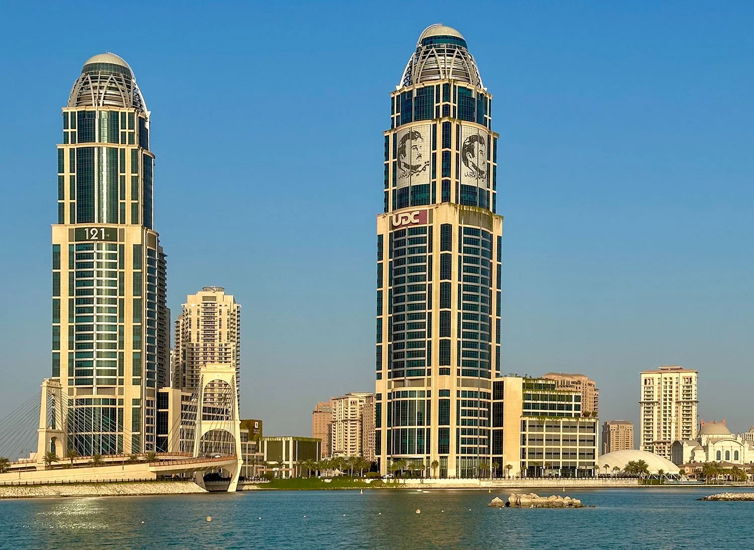View across to The Pearl Island from Legtaifiya Beach in Doha, Qatar, with two architecturally striking skyscraper structures in the middle distance..