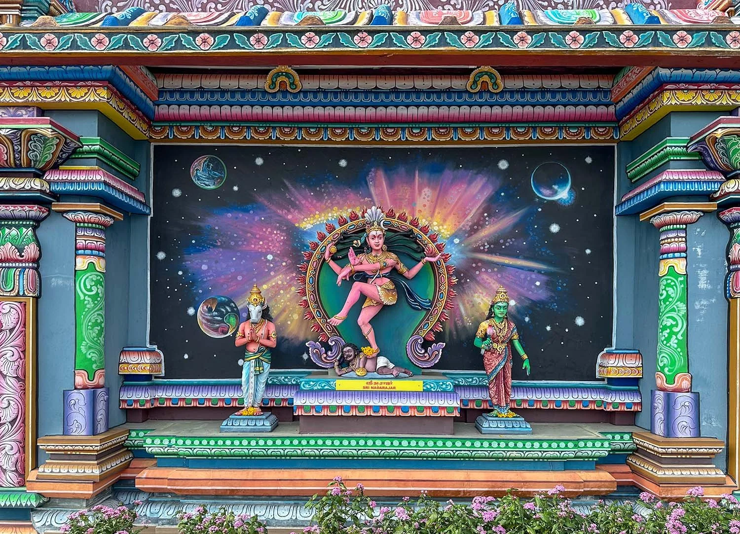 A colourful mural at an Indian temple on Penang Hill, Penang Island, Malaysia, featuring bas-relief and sculptures of mythology figures.