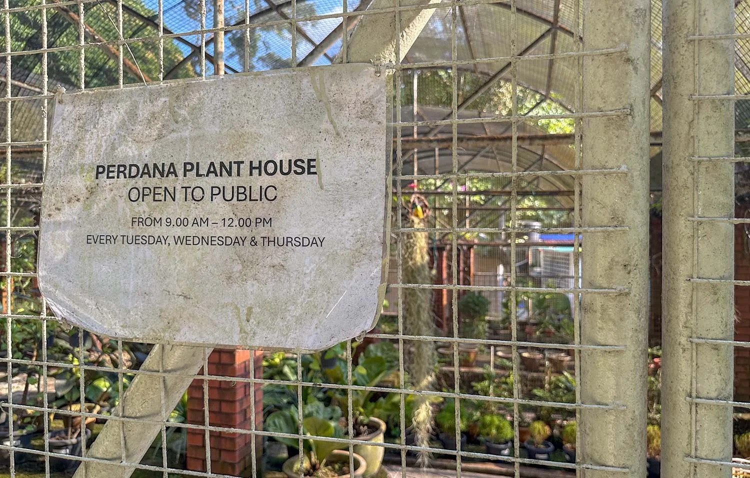 A dirty sign on one of the closed plant houses at the botanic gardens on Penang Island, Malaysia..