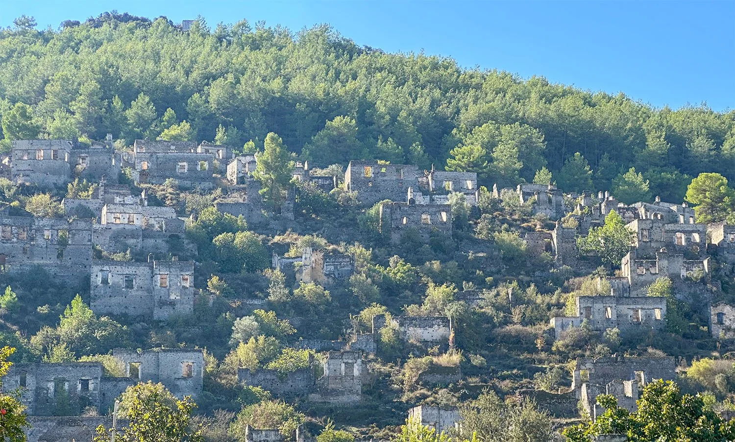 Abandoned stone houses on a hillside near Fethiye on the Turkish Riviera.
