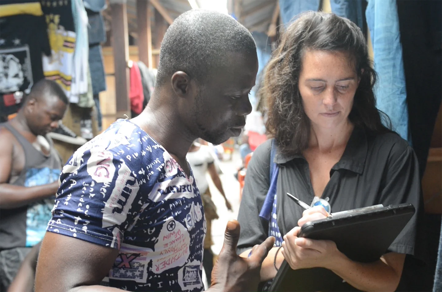 Liz Ricketts talking to a trader in the marketplace