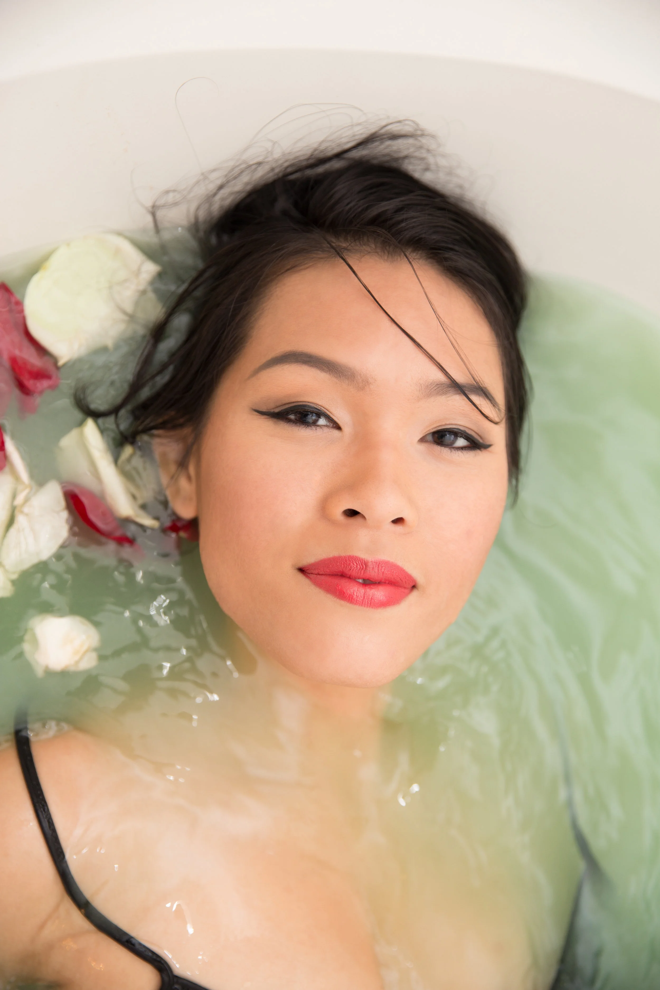 teal bath with rose petals