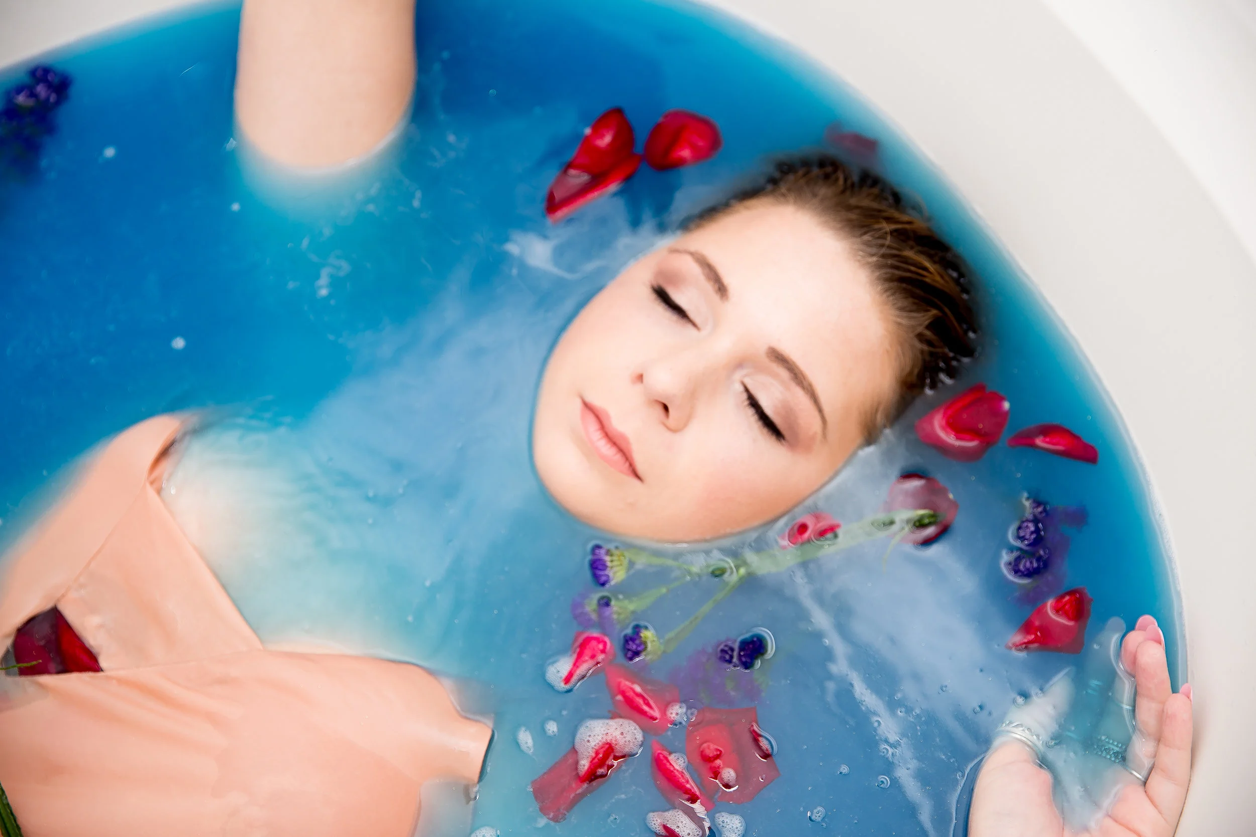 blue bath closeup with rose petals