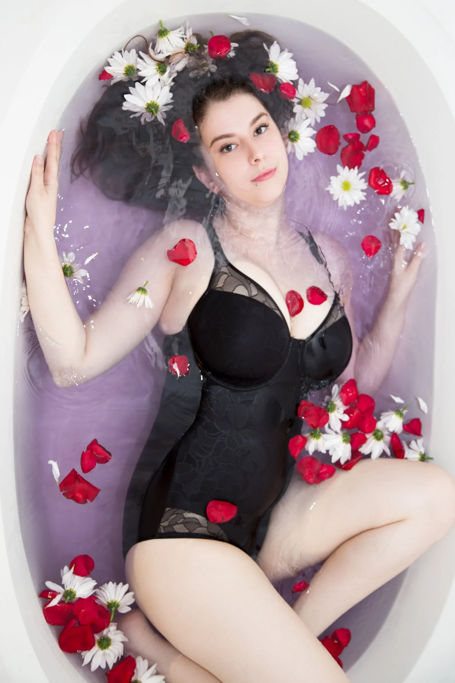 purple bath with daisies and rose petals