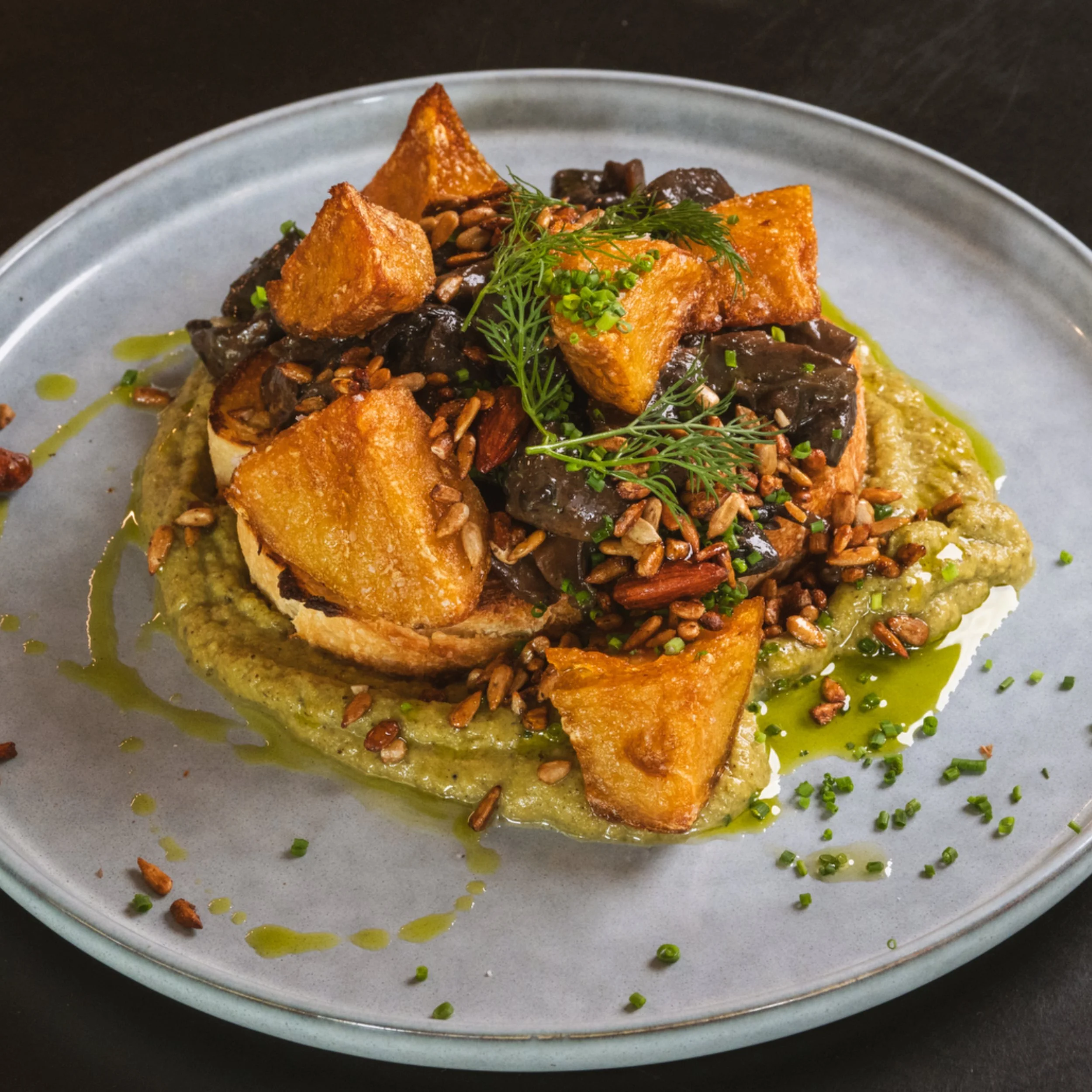Sautéed mushrooms on toast with herbs and seeds at ALL DAY café in West End Brisbane