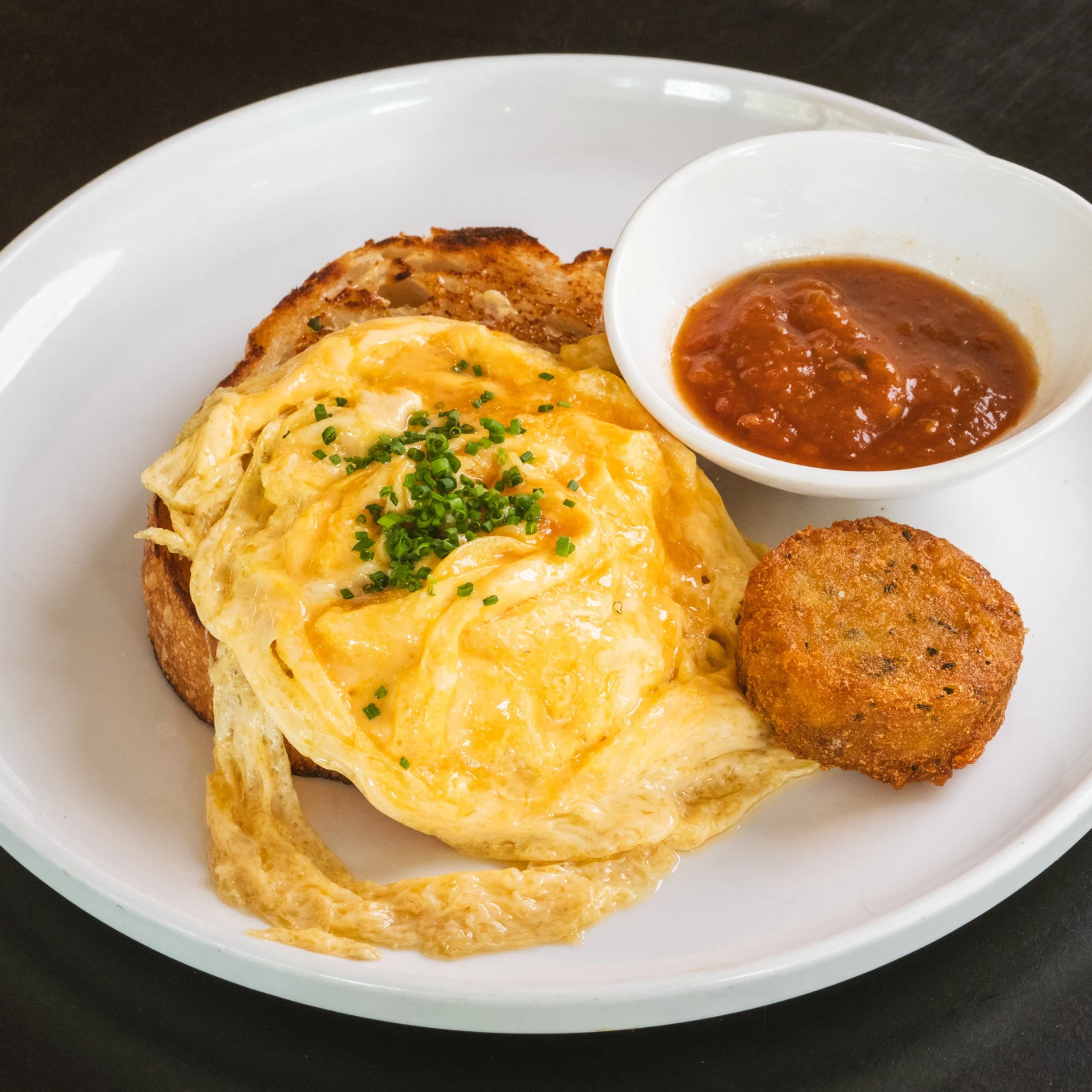 Soft scrambled eggs on toasted sourdough at ALL DAY café in West End Brisbane